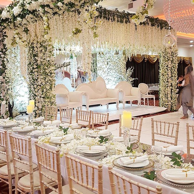 Elegant ballroom with floral backdrop, ideal for weddings and upscale events.