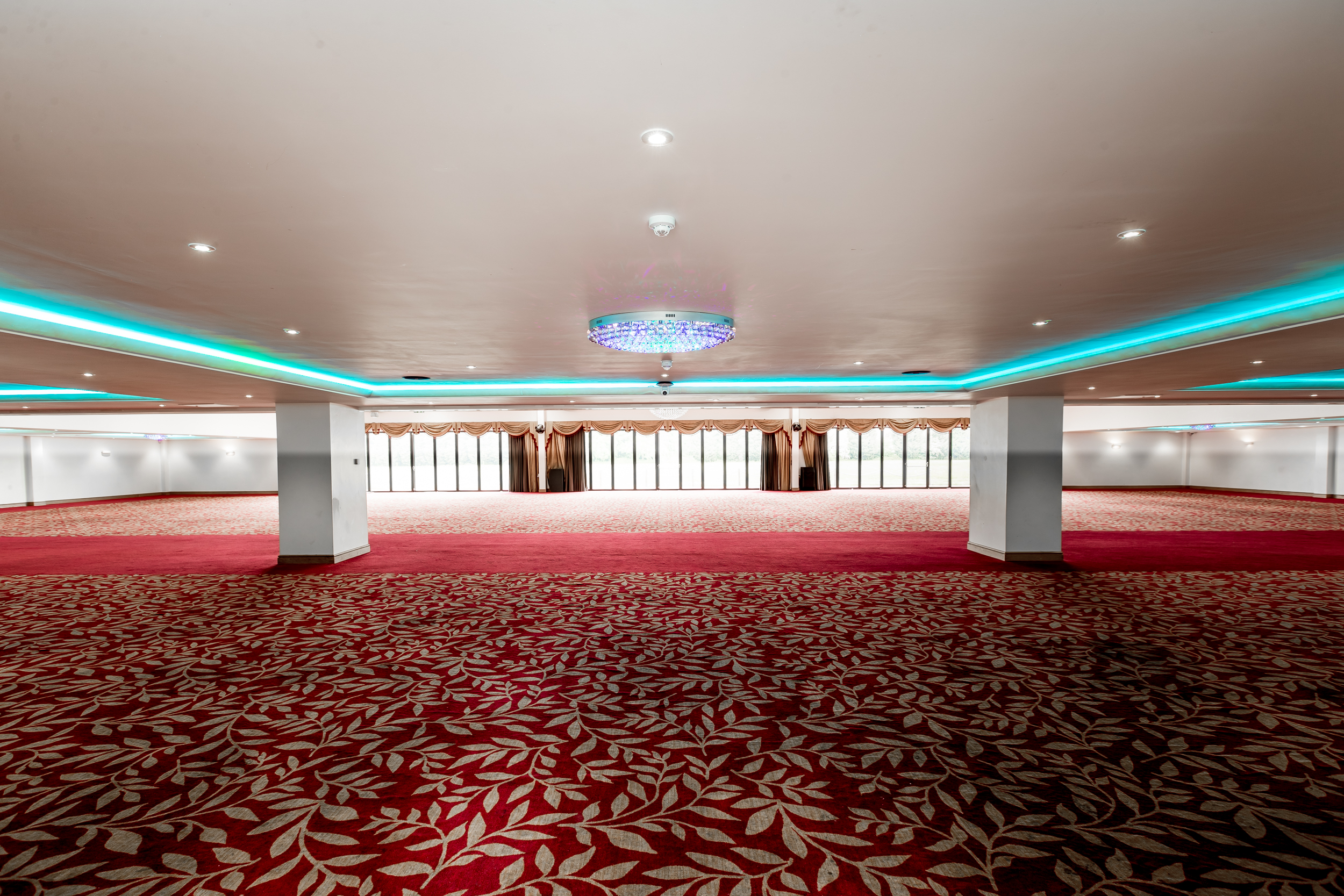 Spacious event venue with elegant carpeting, ideal for conferences and banquets.