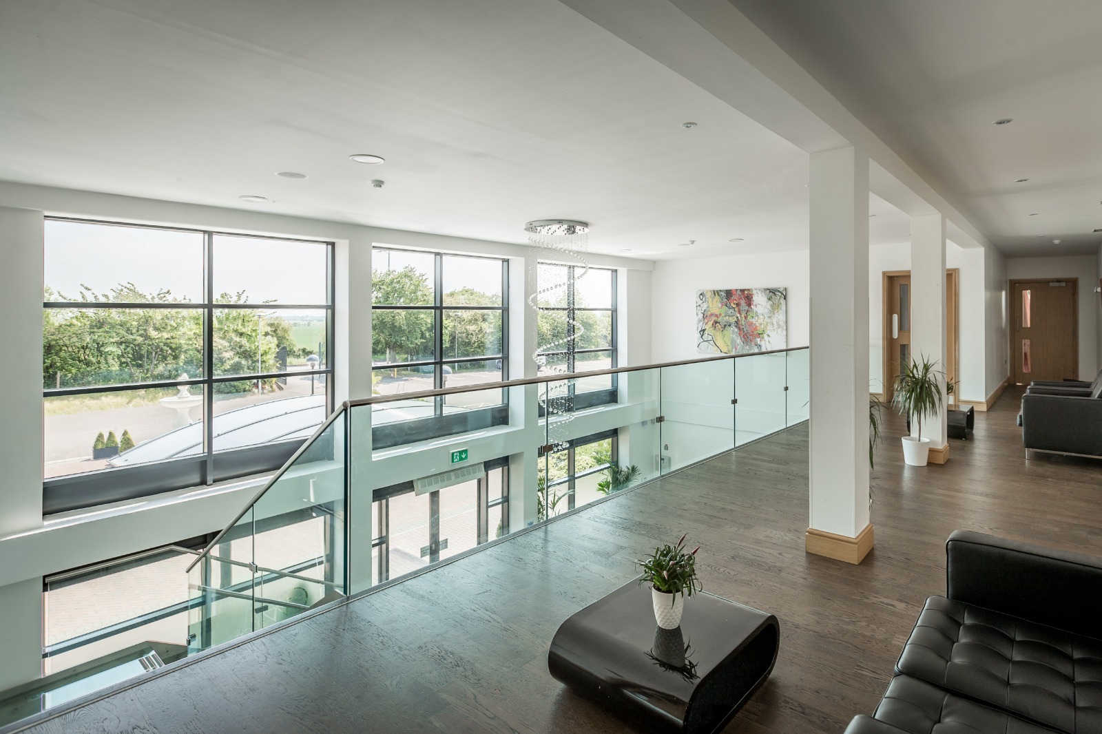 Modern Premier Suite with large windows, perfect for meetings and networking events.