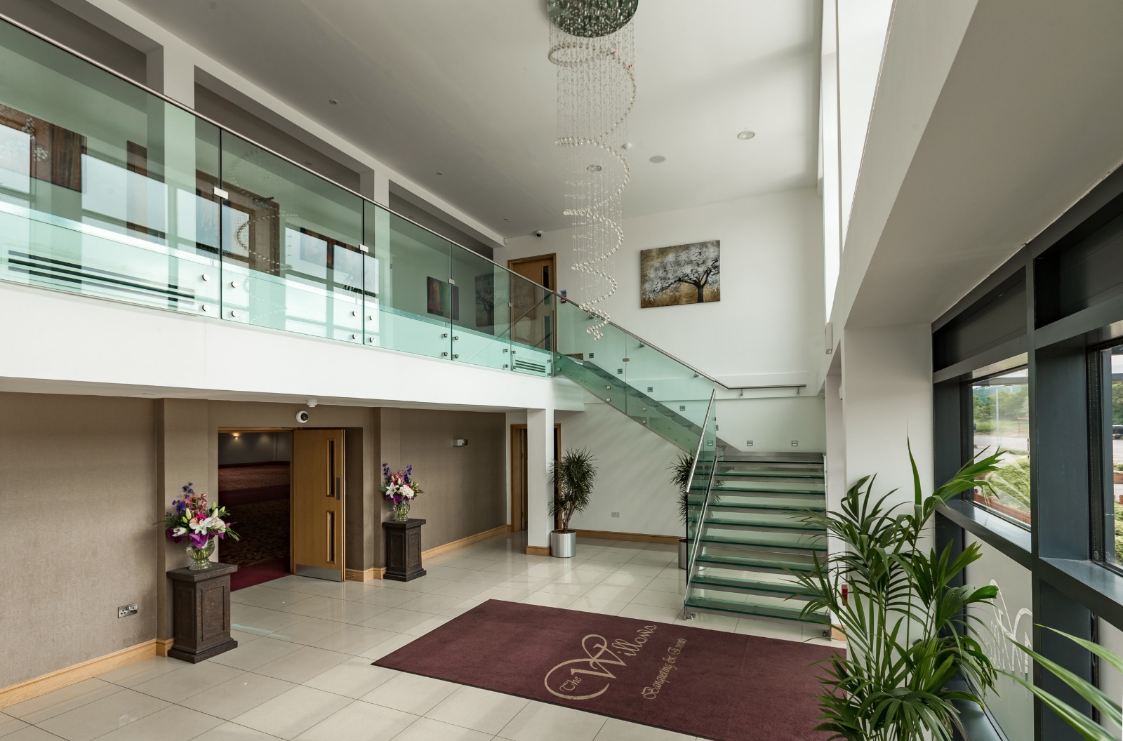 Elegant Premier Suite lobby with natural light, ideal for networking events and receptions.