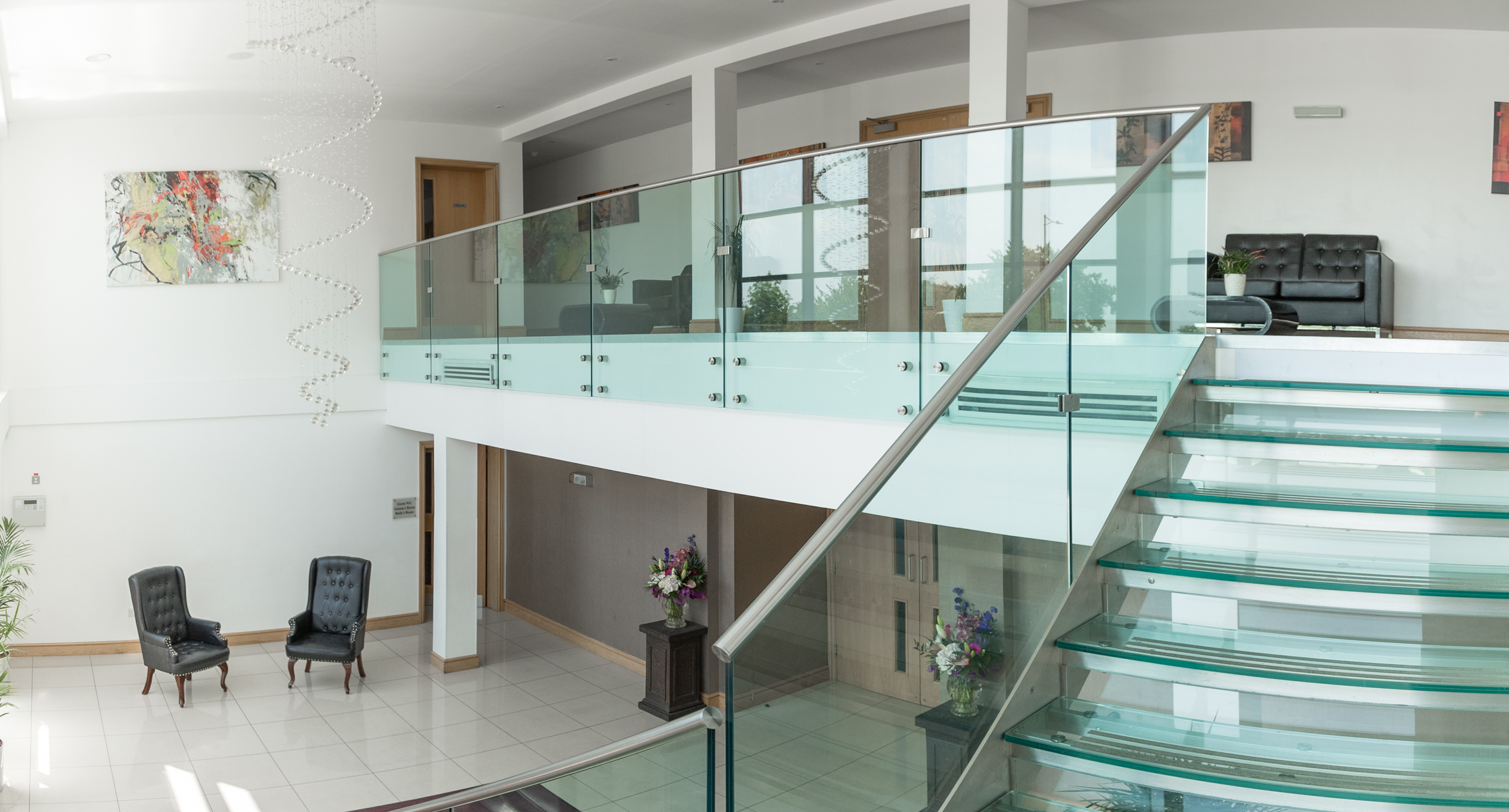 Modern Premier Suite with glass staircase, perfect for upscale meetings and events.
