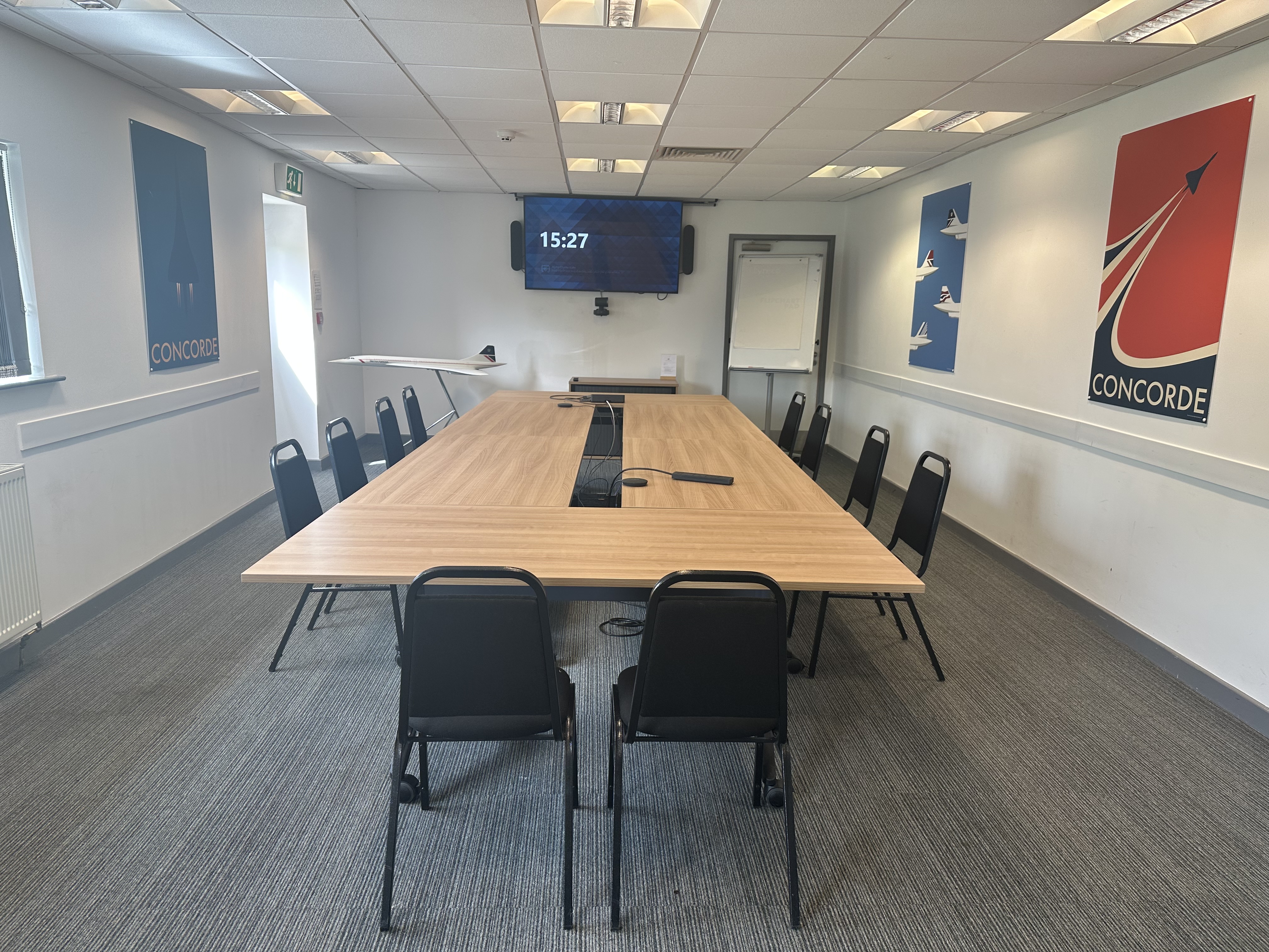 Modern meeting room with large wooden table at Concorde Conference Centre for events.