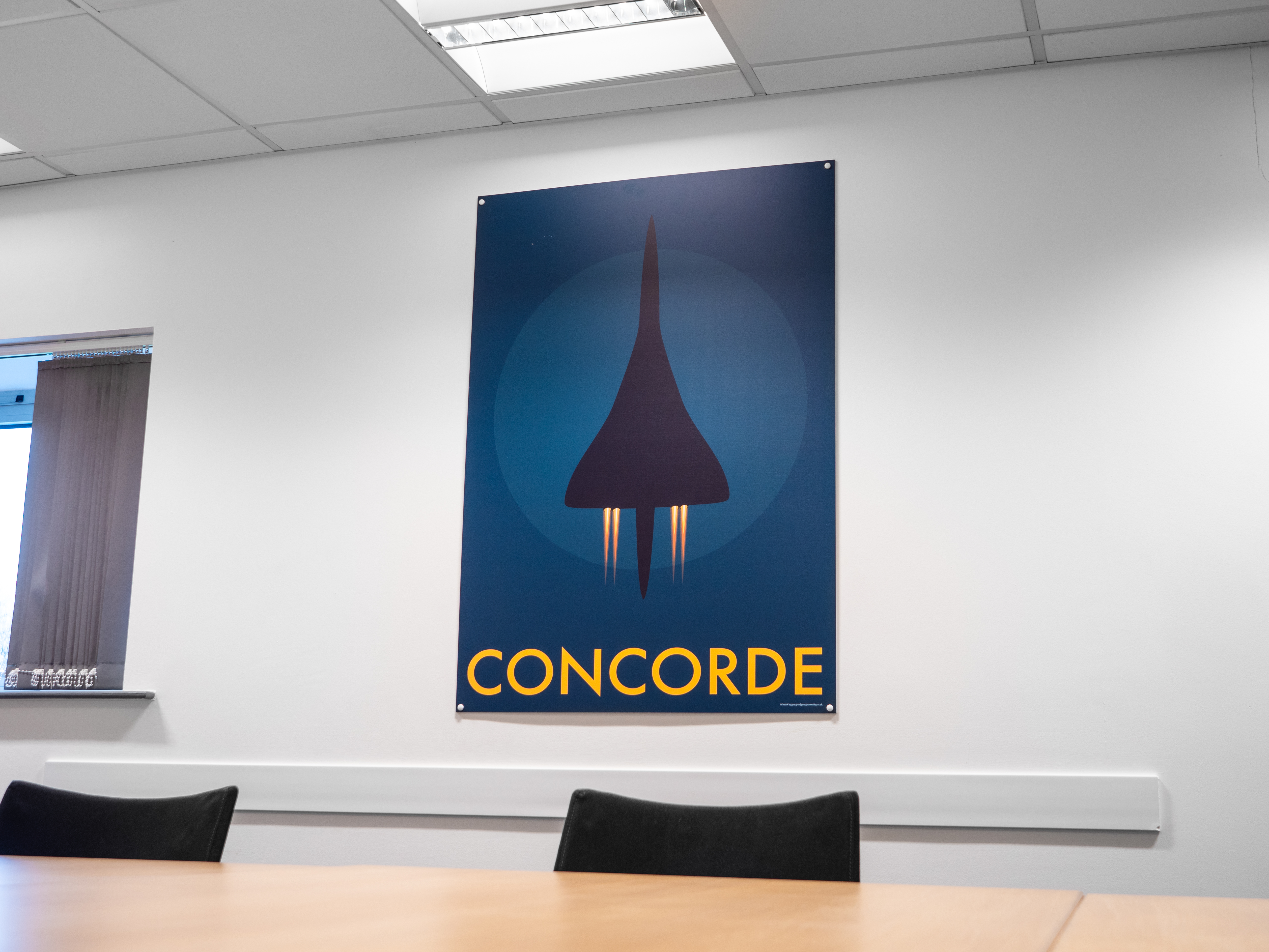 Alpha Charlie Suite with Concorde poster, ideal for aviation and luxury events.
