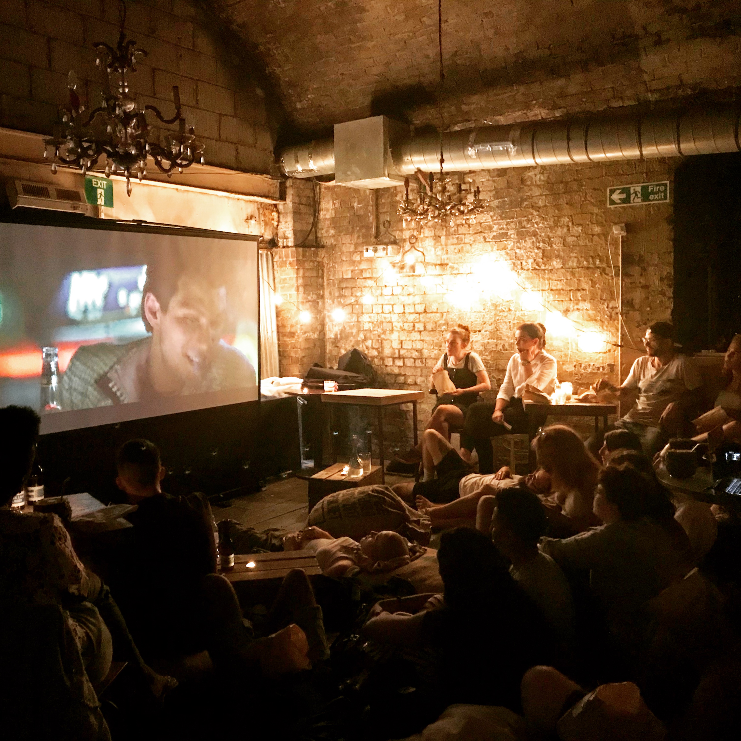 Cozy event space with warm lighting for film screenings and social gatherings.