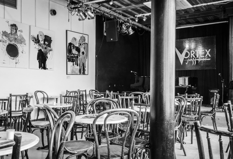 Versatile Vortex Main Room with artistic decor, ideal for networking events and performances.