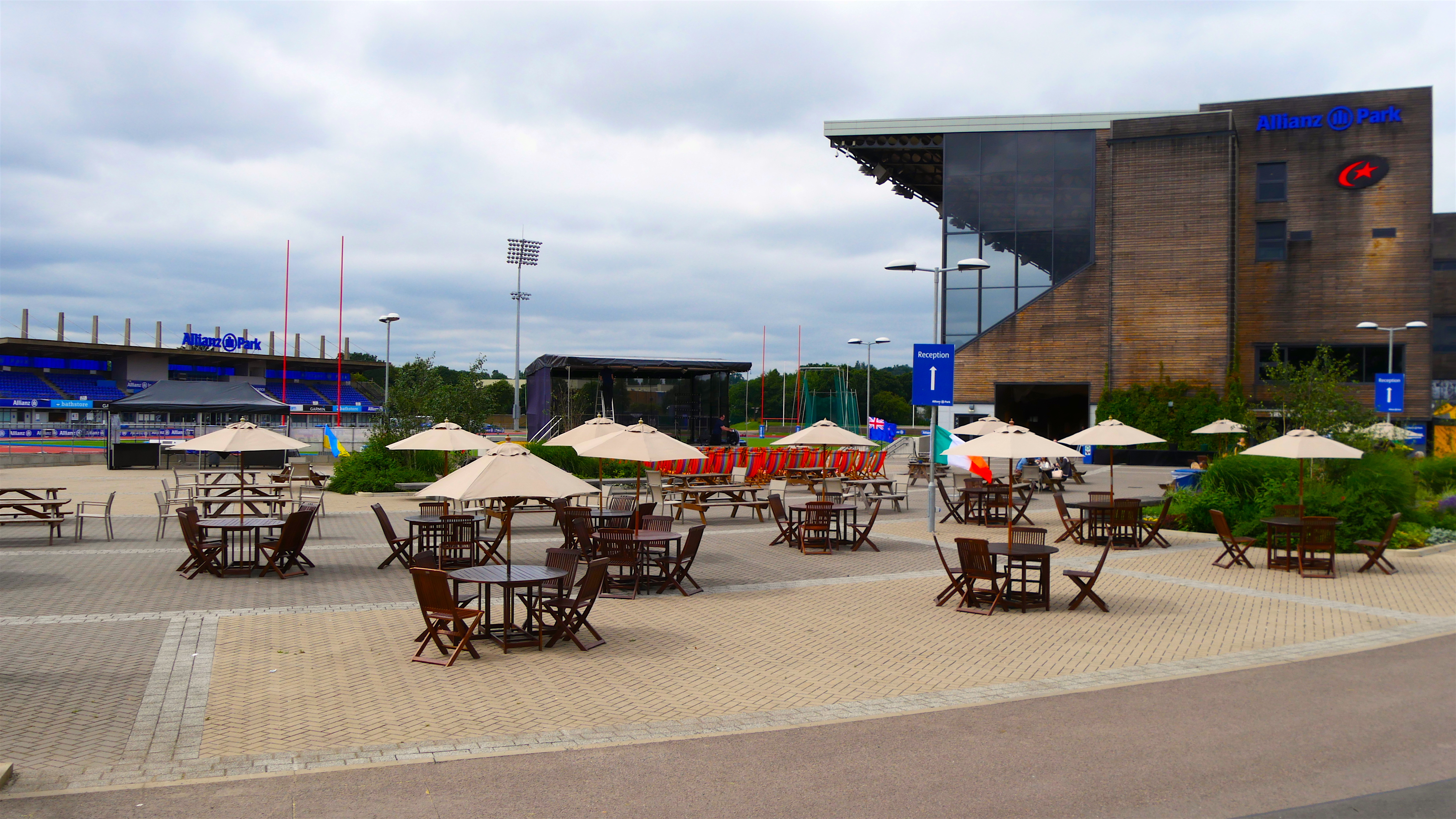 Outdoor event space at The Hundred Club, featuring tables and umbrellas for gatherings.