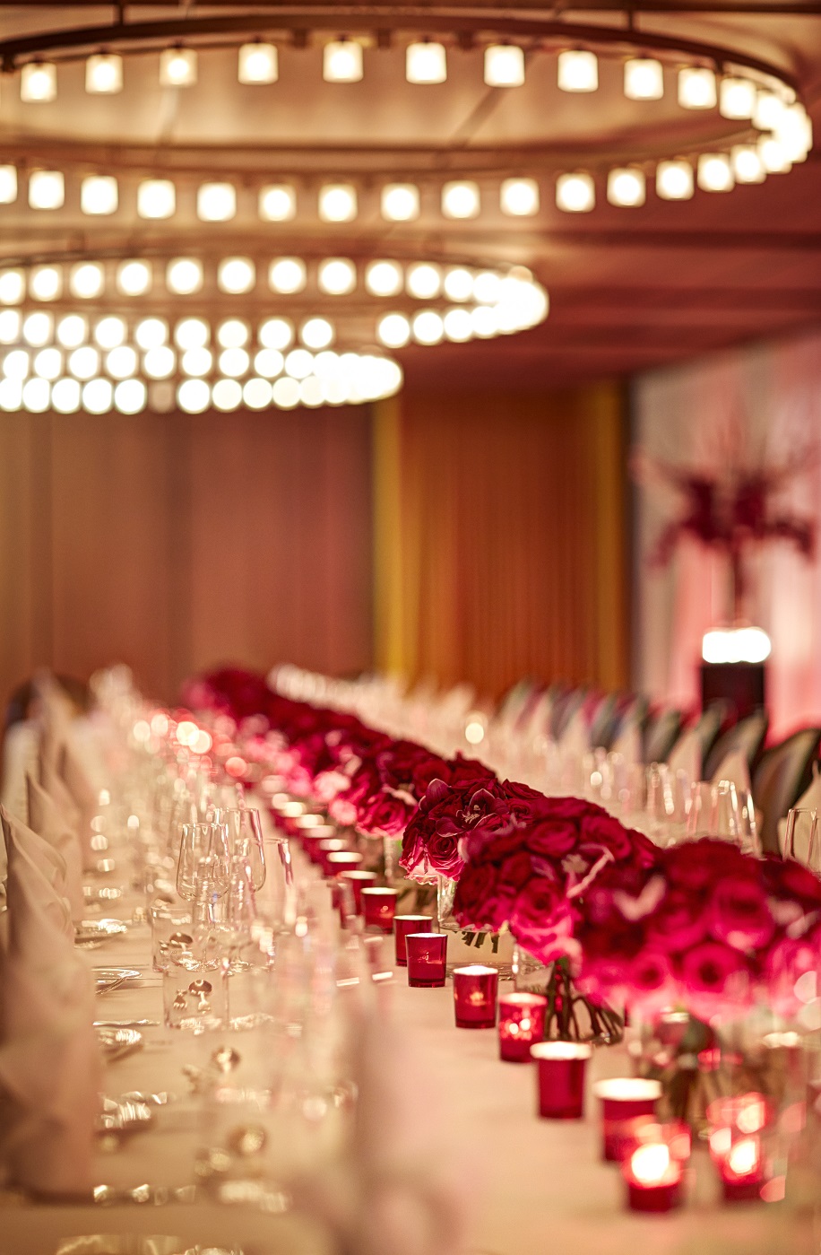 Elegant dining table with red flowers at Hotel Cafe Royal for upscale events.