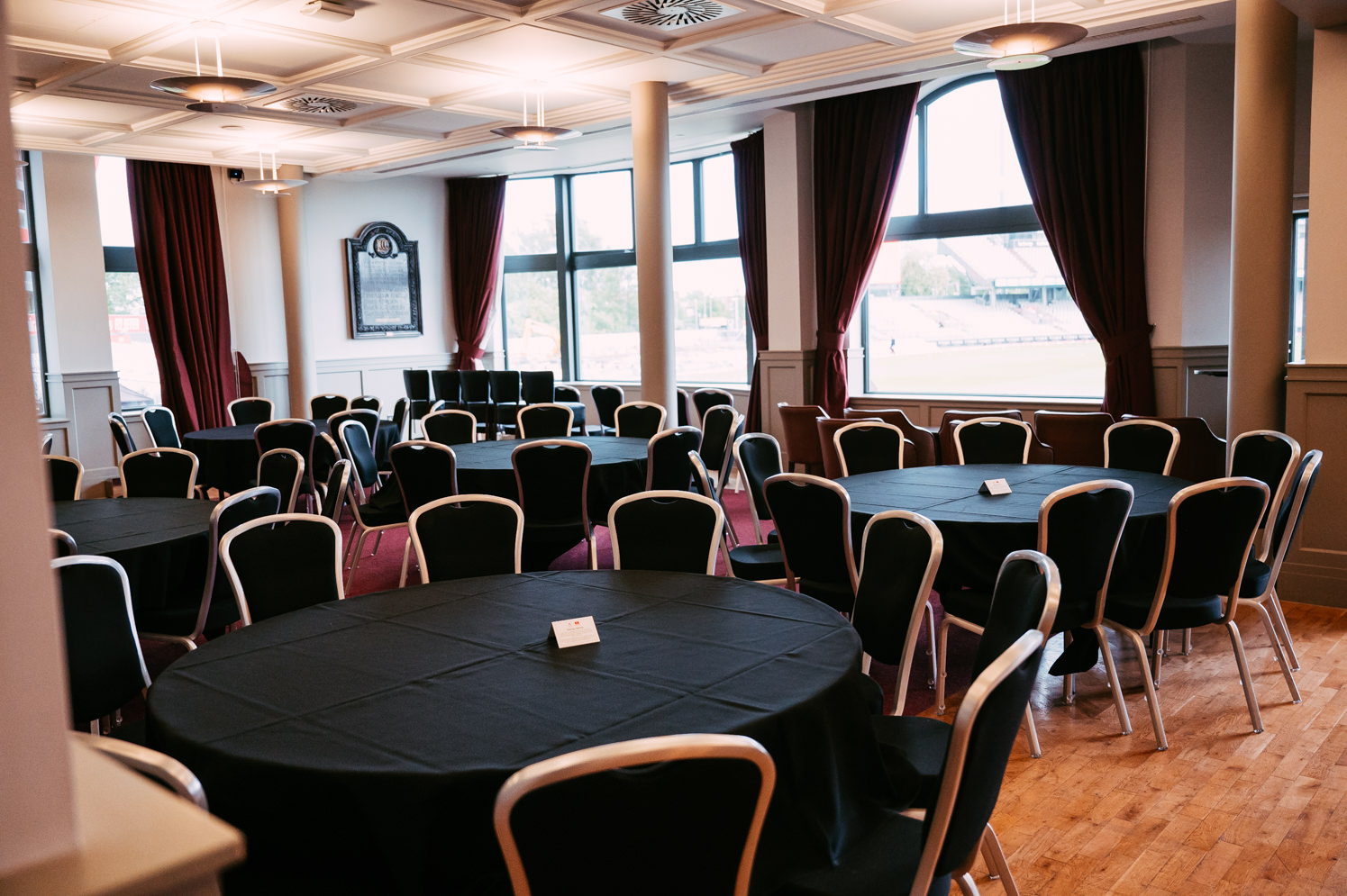 Elegant event space with round tables at Emirates Old Trafford for corporate meetings and banquets.