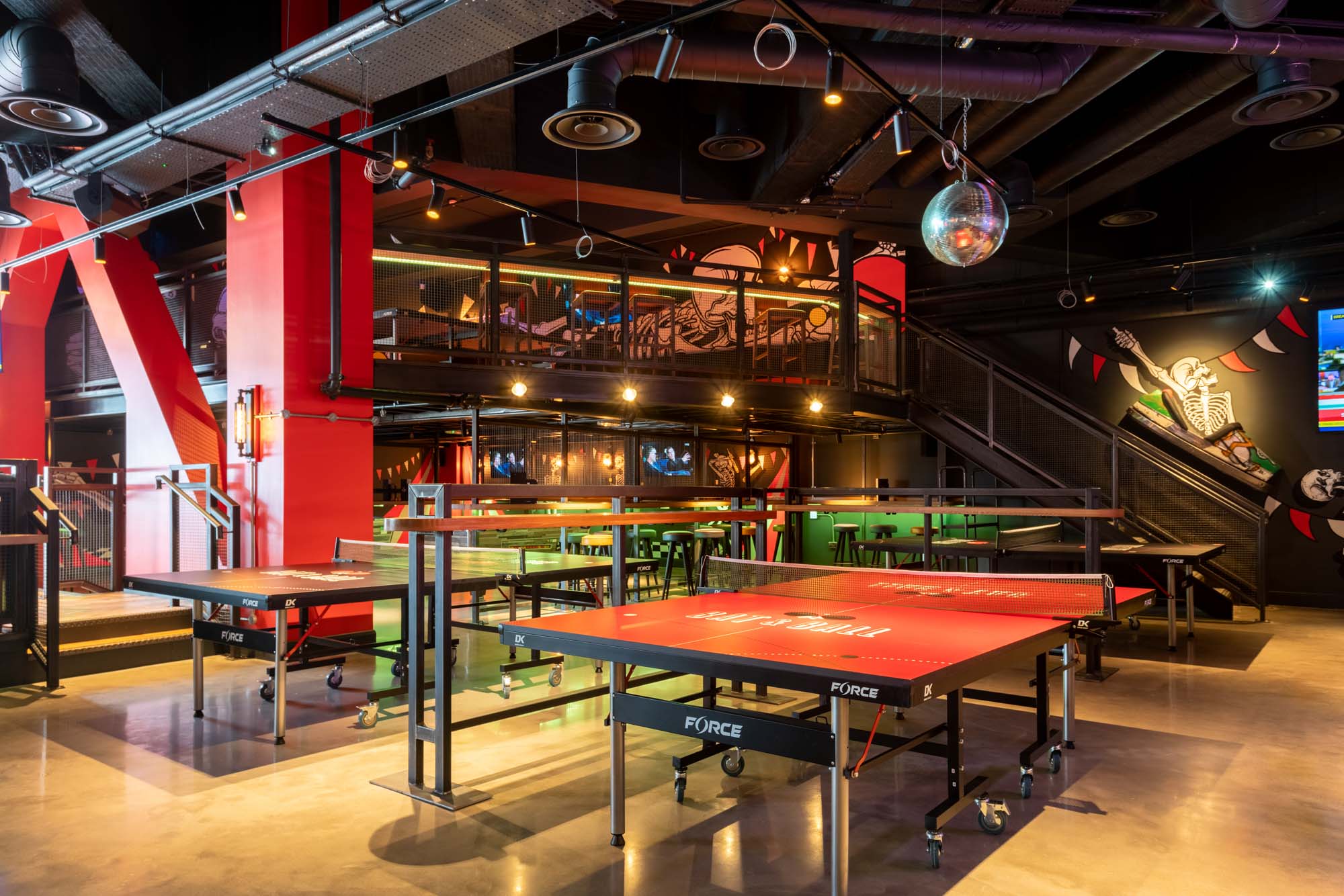 Vibrant event space with ping pong tables for parties and team-building activities.
