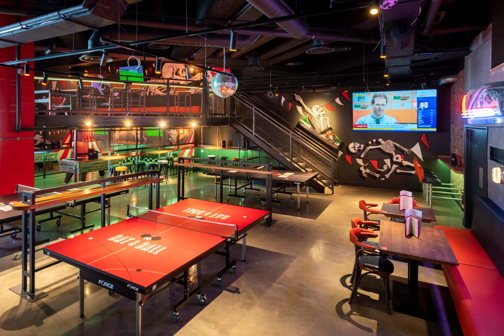 Vibrant event space with ping pong tables for corporate retreats and networking parties.