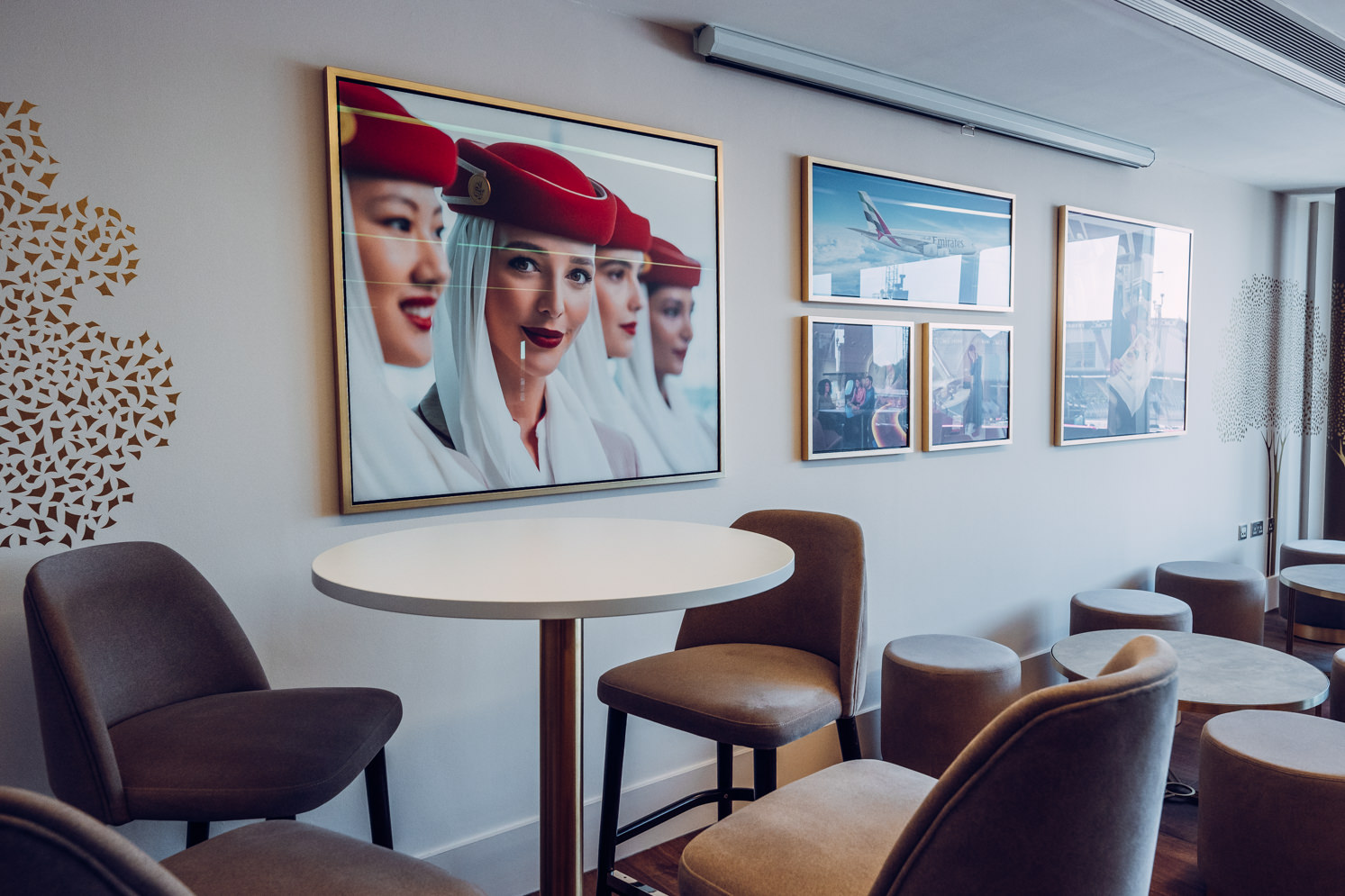 Emirates Lounge at Old Trafford: modern event space with stylish seating and airline art.
