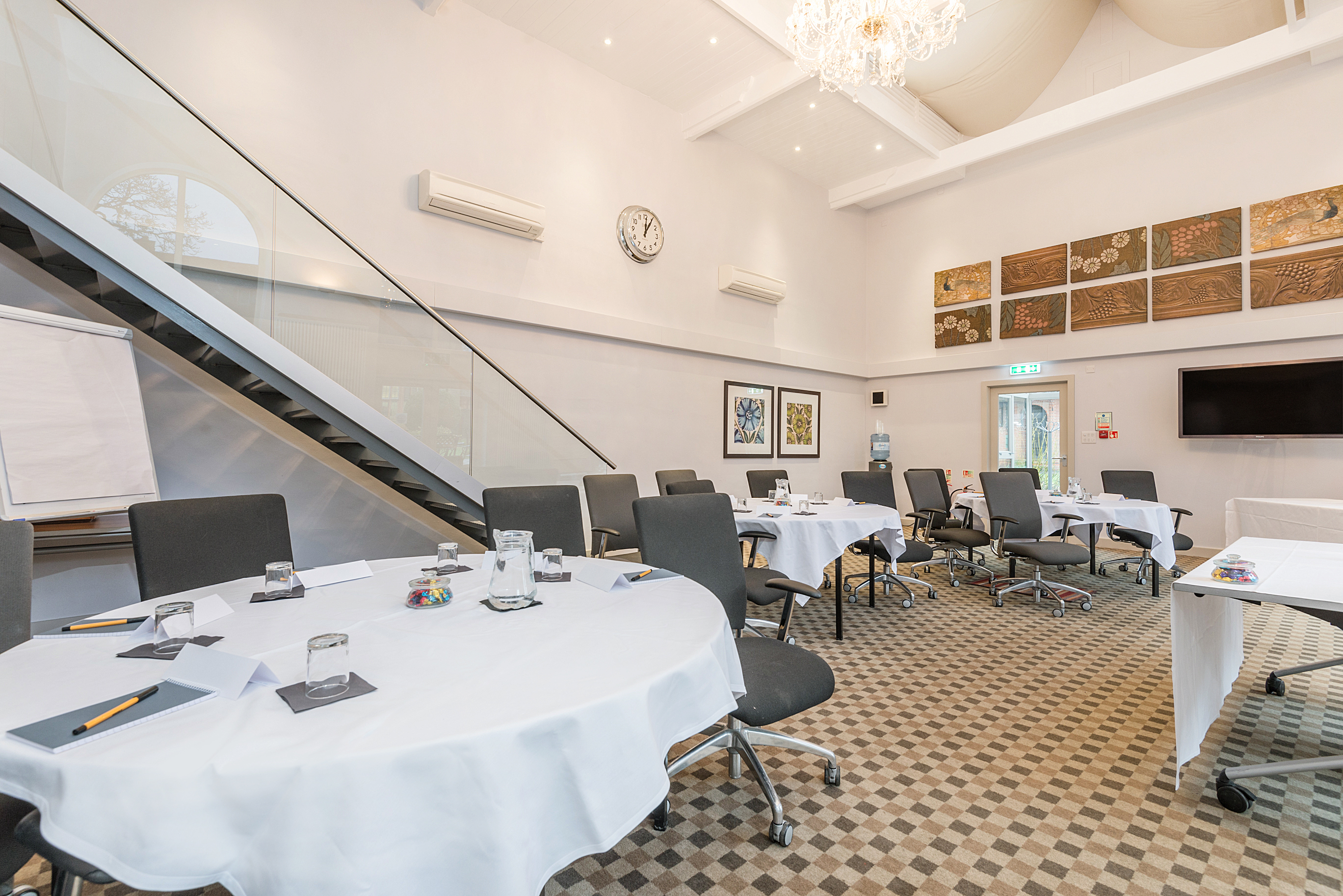 Meeting room at New Place Hotel, Hampshire with round tables for workshops and conferences.