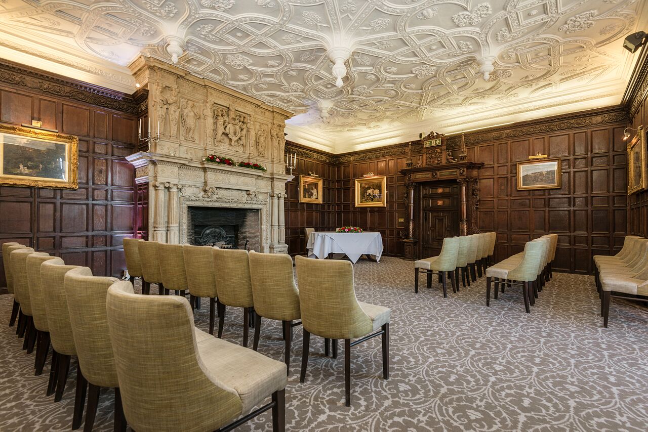 Sophisticated meeting room with wood paneling at New Place Hotel, ideal for corporate events.