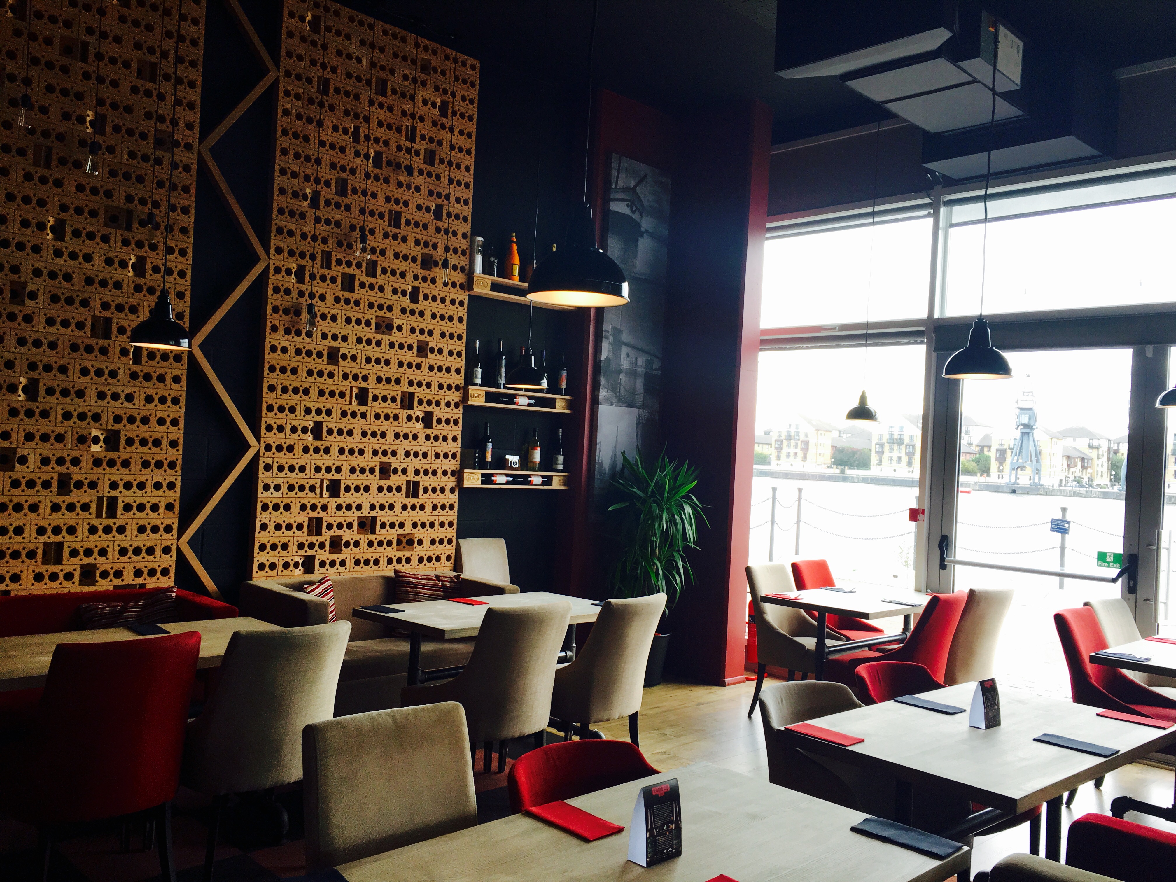 Modern restaurant interior with wooden accents, perfect for gatherings and meetings.