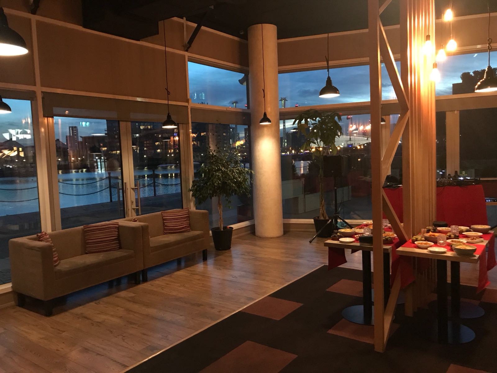 Stylish event space with large windows, ideal for networking and social gatherings.