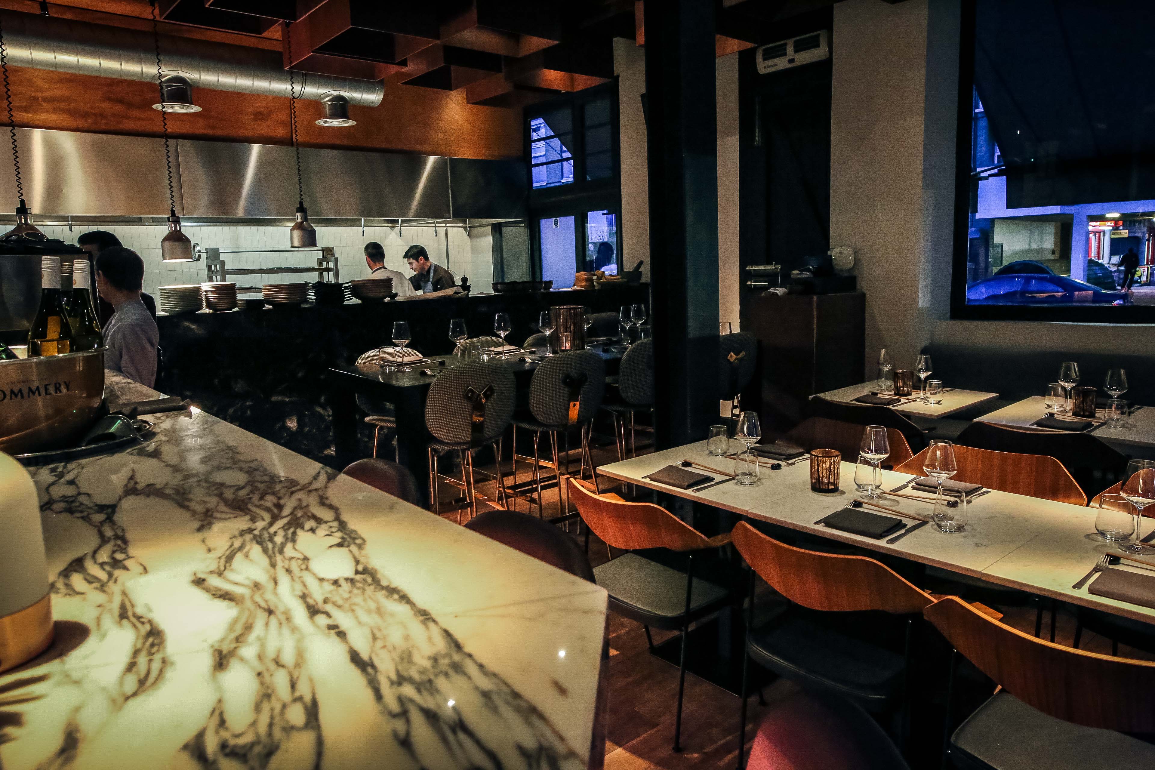 Modern sushi bar with elegant marble, ideal for corporate dinners and intimate gatherings.