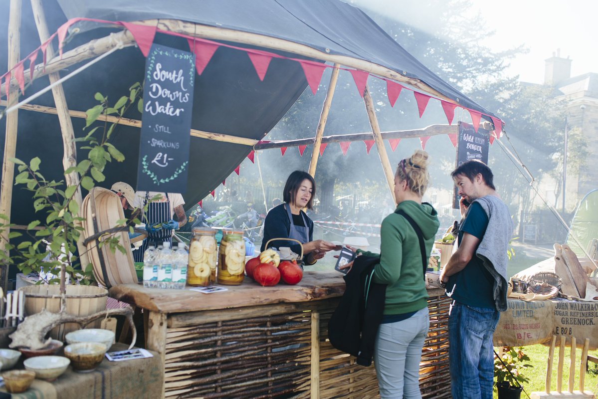 Vibrant outdoor market stall at Proud Country House for community events and networking.