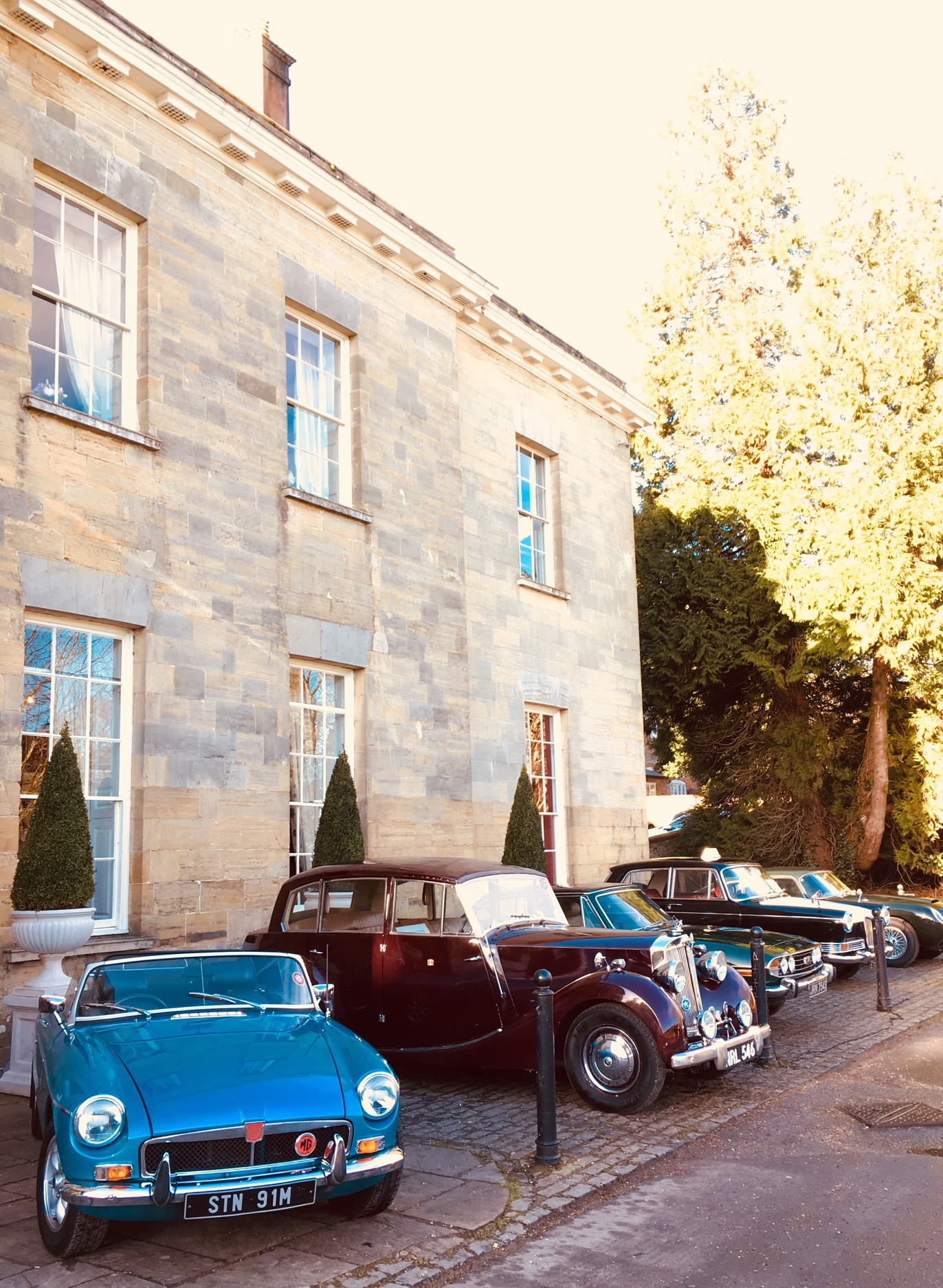 Garden and marquee at Proud Country House, featuring classic cars for upscale events.