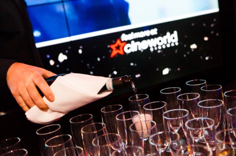Professional pouring drinks into elegant glasses at upscale event in Cineworld O2 Greenwich.