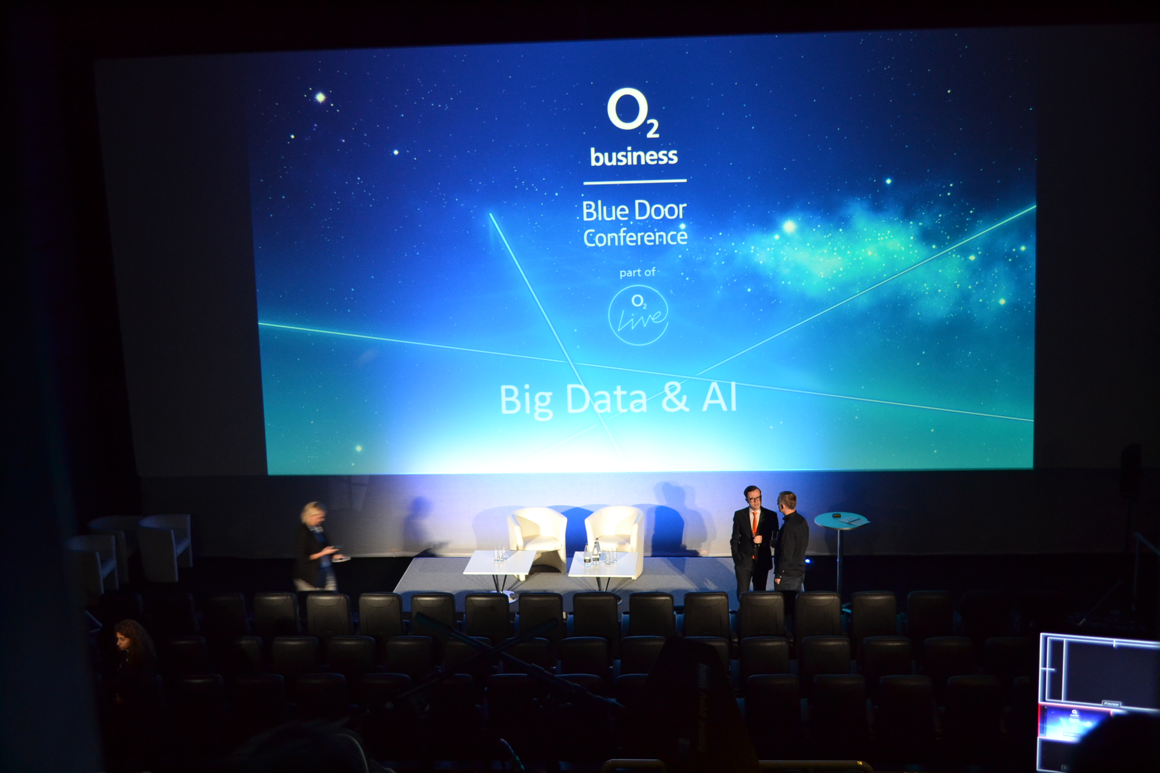 Medium screen at O2 Greenwich for Big Data & AI conference, minimalist setup, professional event.