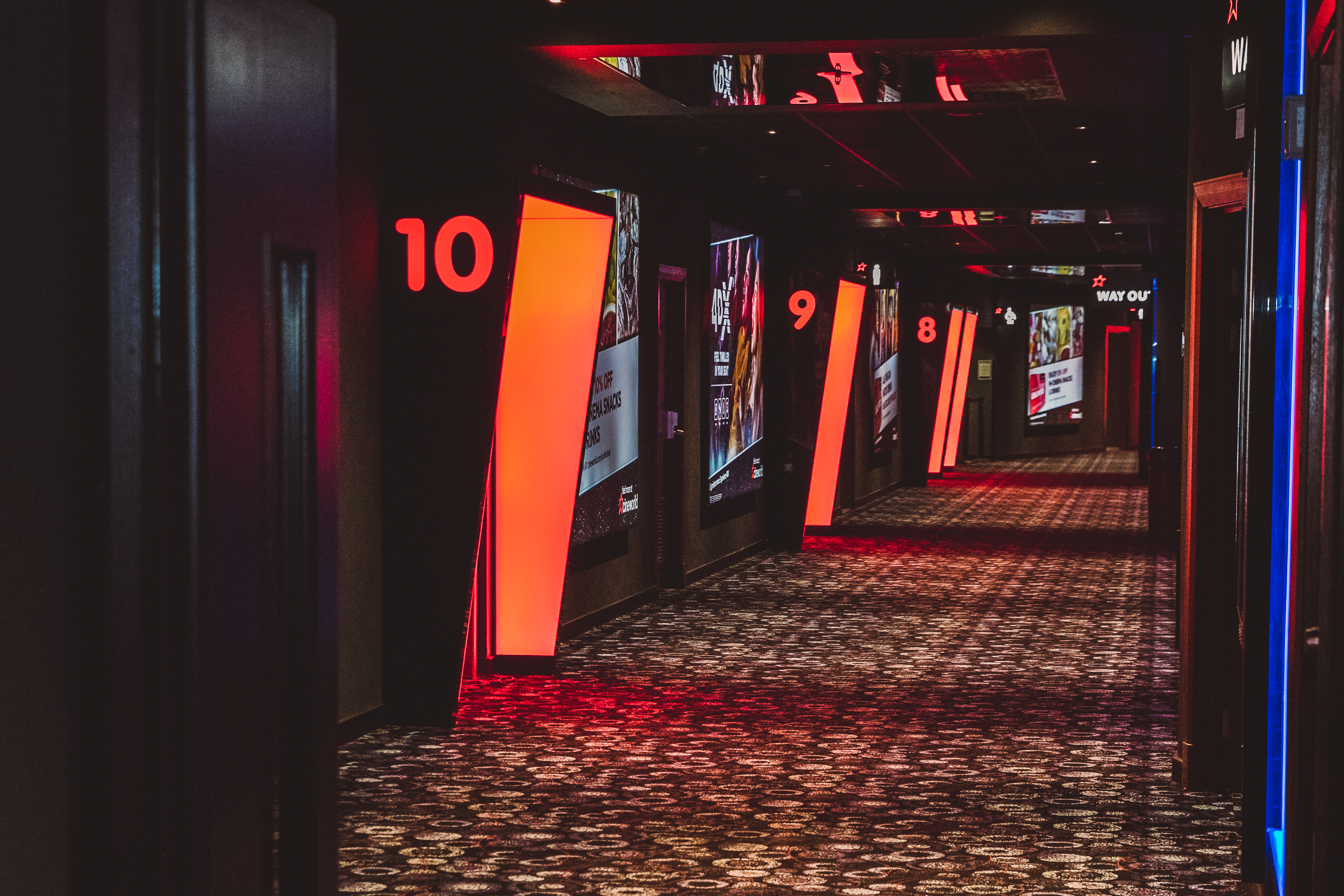 Modern corridor with digital displays at Cineworld O2, ideal for conferences and exhibitions.