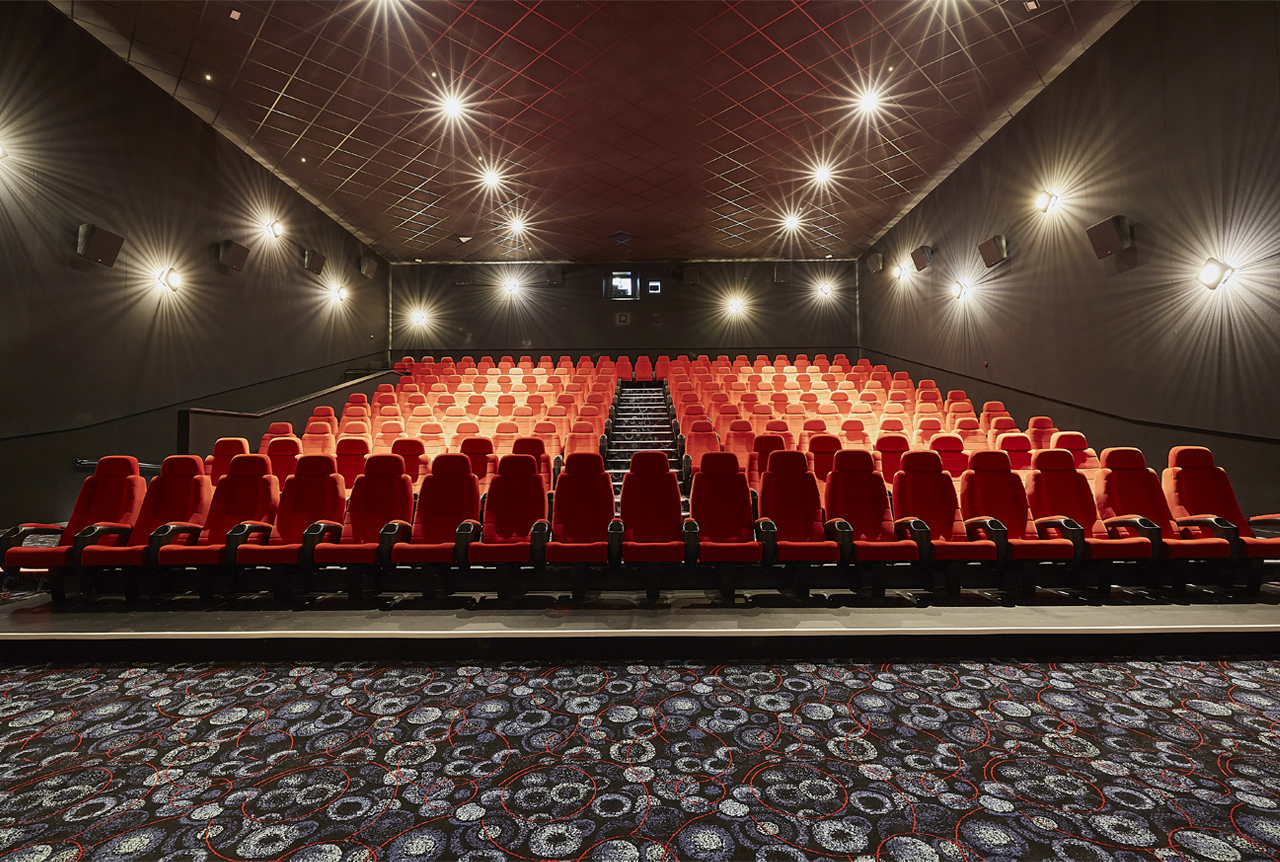 Modern theater with red seating in Cineworld Birmingham for film screenings and corporate events.