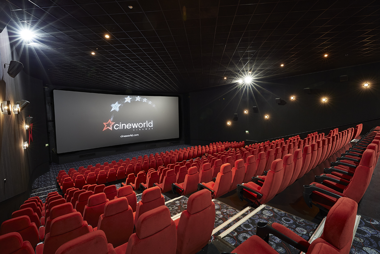 Large screen cinema auditorium with plush red seating in Cineworld Birmingham.