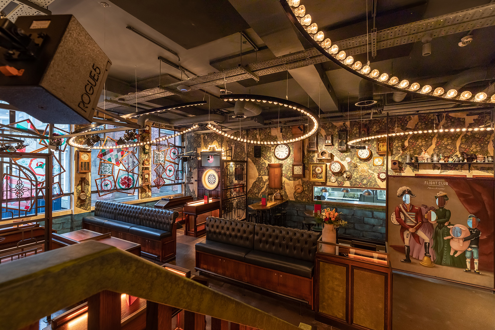 Stylish event venue in Flight Club Manchester with vibrant decor and ambient lighting.