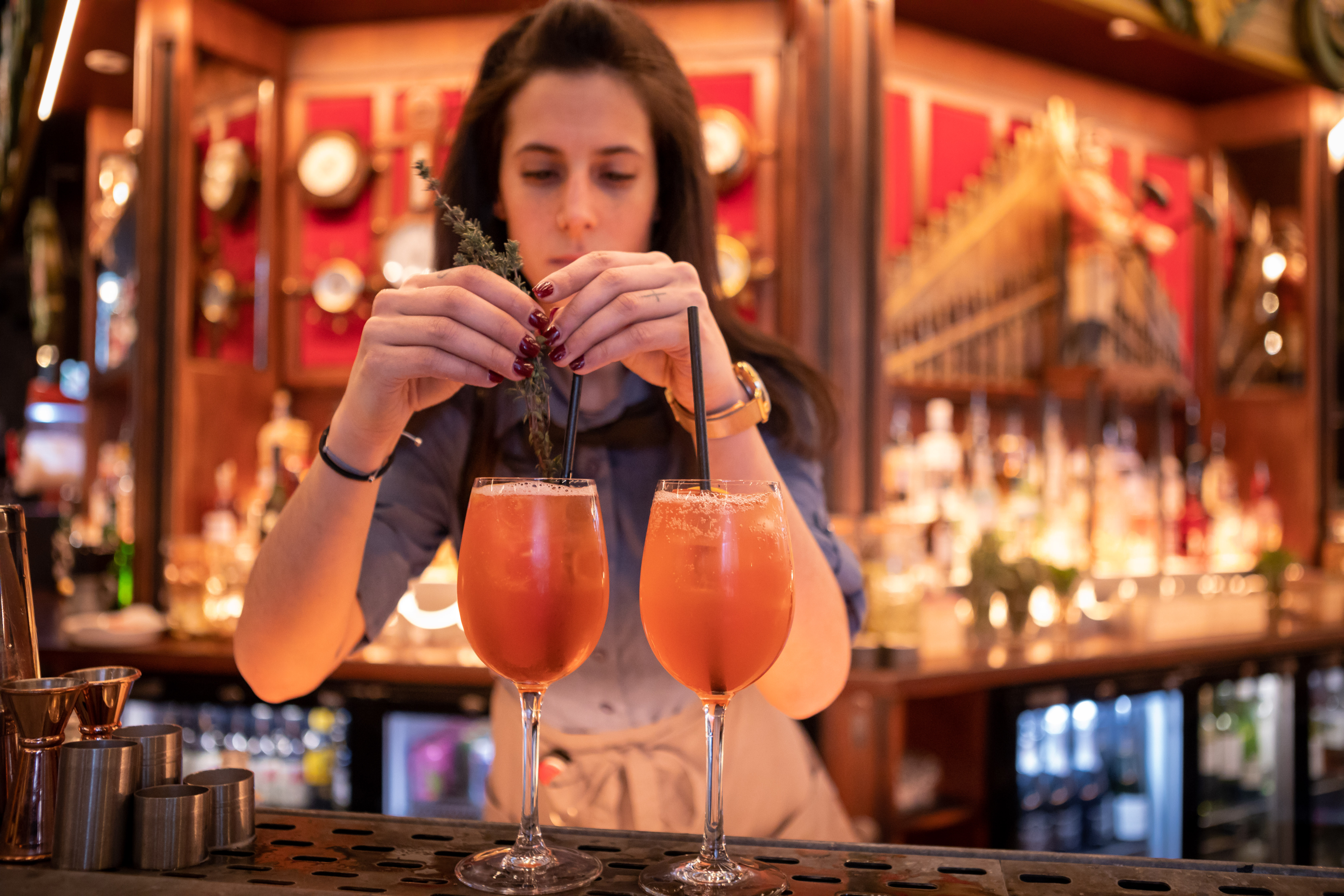 Bartender crafting vibrant cocktails at Flight Club Manchester for social events.