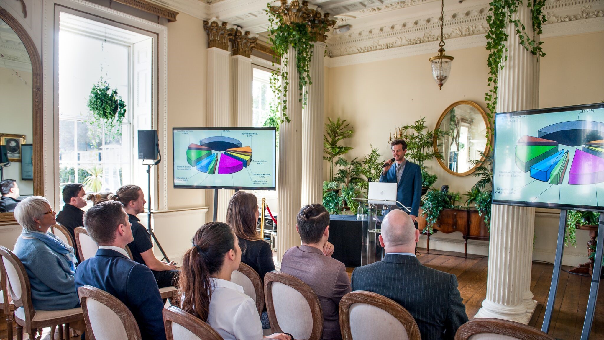 Elegant marquee meeting space with presenter and engaged audience at Proud Country House.