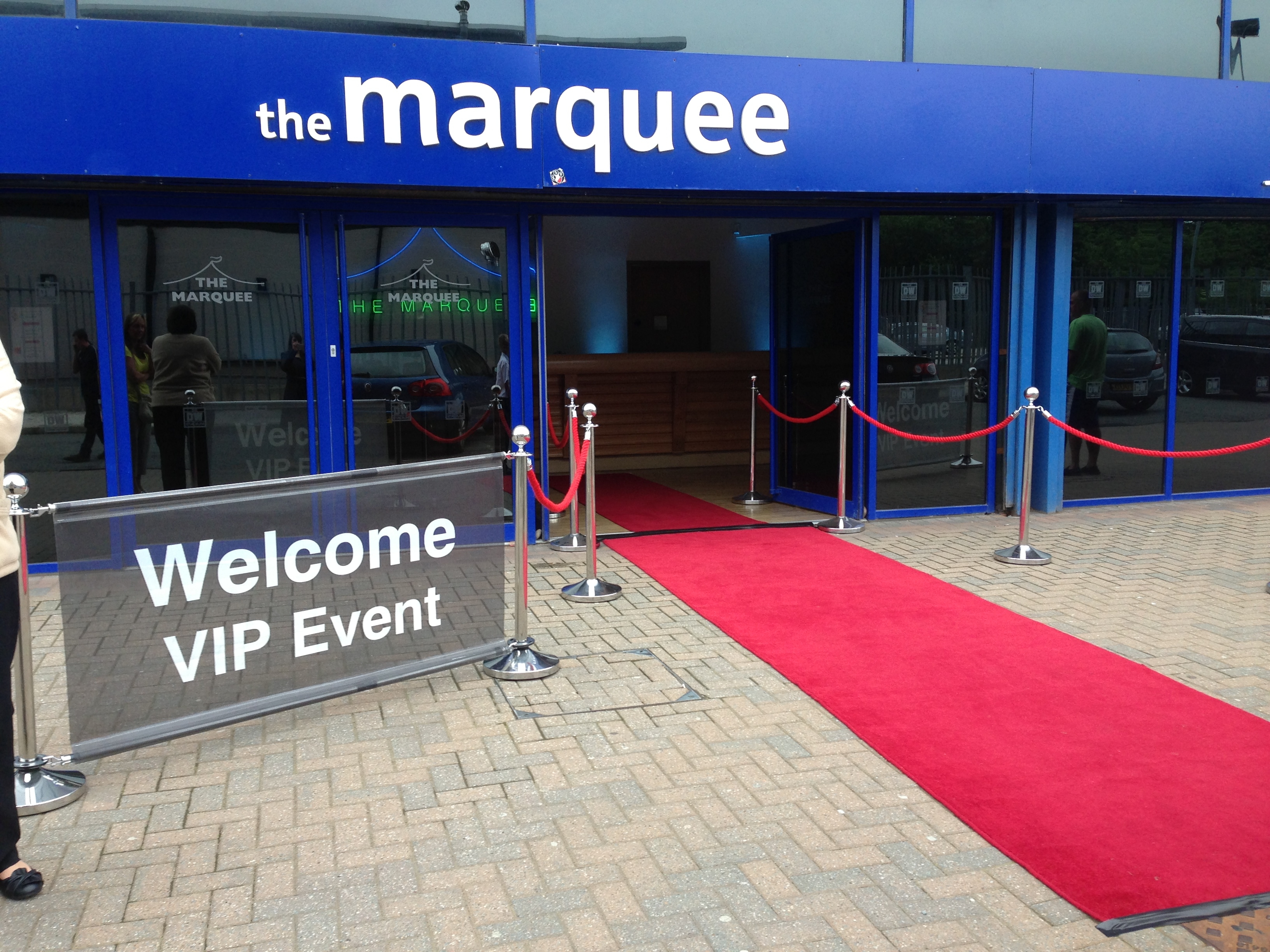 VIP event entrance at The Marquee, featuring a red carpet and elegant stanchions.