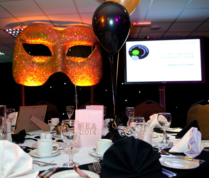 DW Sports Fitness Lounge event setup with decorative mask, ideal for celebrations and presentations.