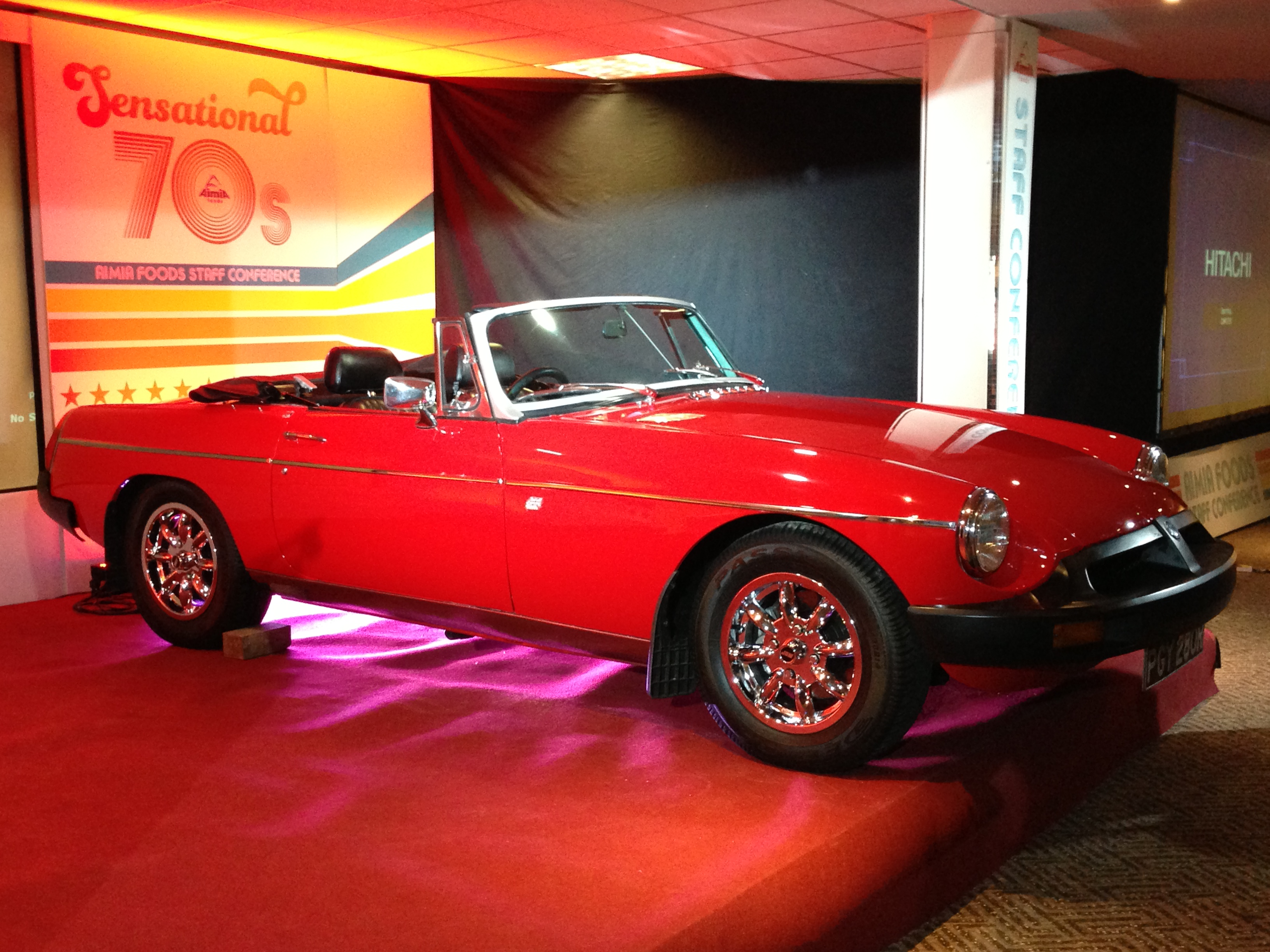 Vibrant red convertible at DW Sports Fitness Lounge for Sensational 70s event.