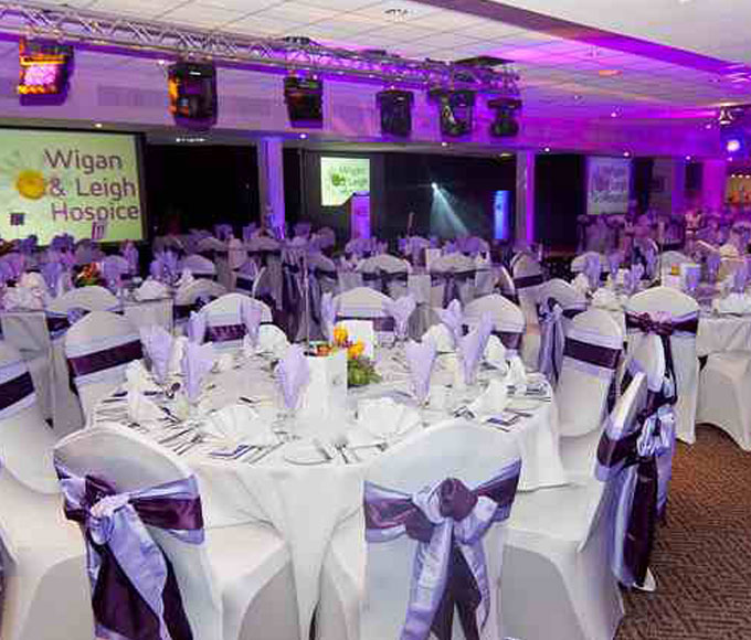 Elegant banquet setup at DW Sports Fitness Lounge for a charity gala event.