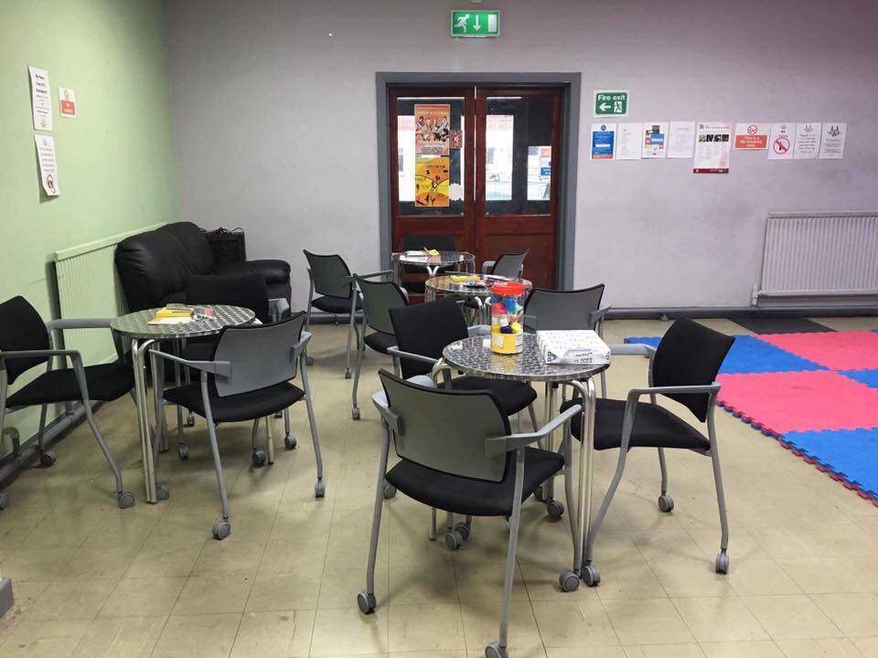 Large hall in St. Mark's Community Centre, colorful mat for casual meetings and brainstorming.