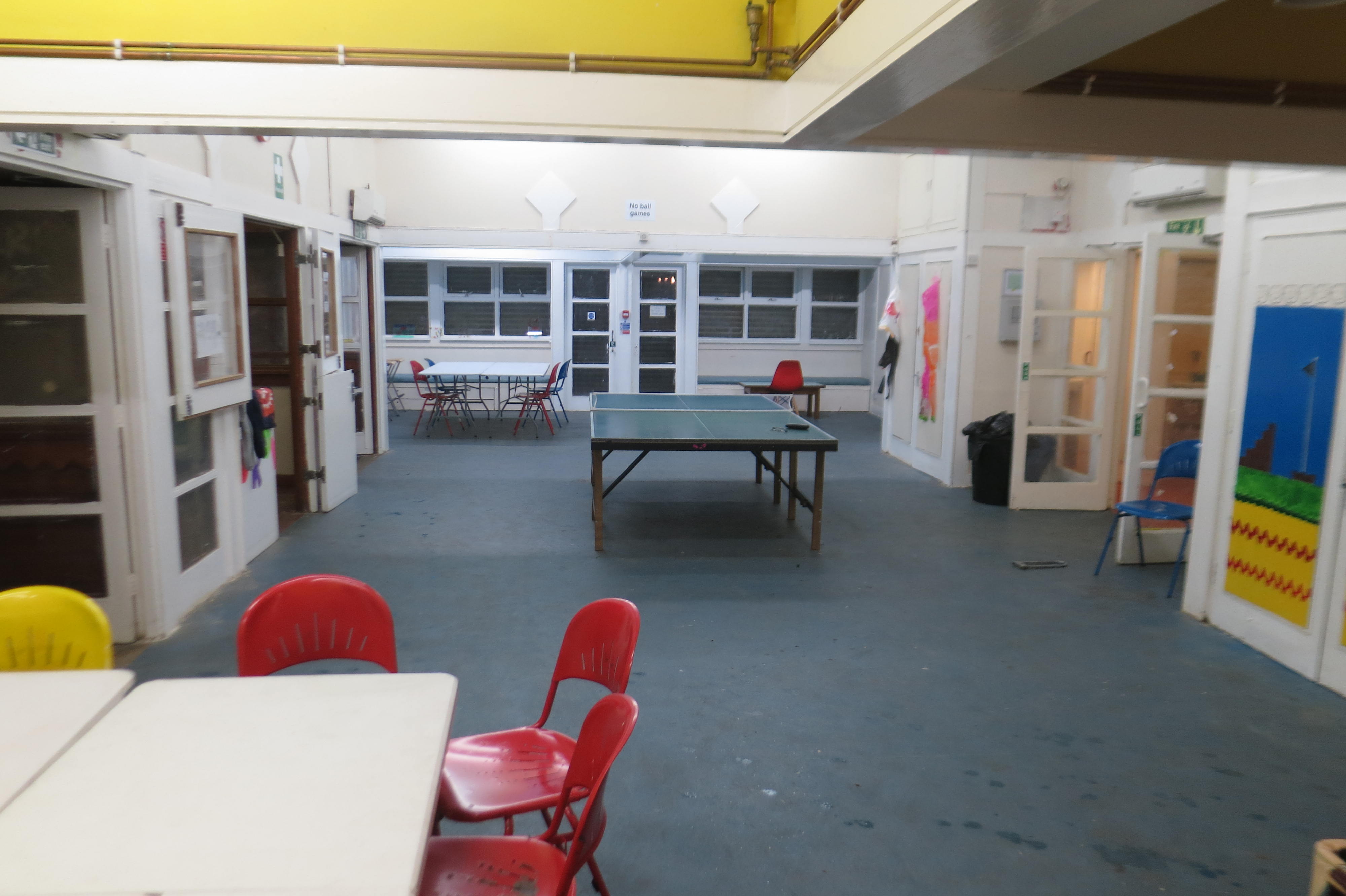 Versatile meeting space with a ping pong table for casual gatherings and workshops.