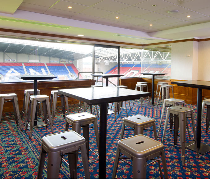 "Dave Whelan President's Suite: modern event space with stadium view for networking and gatherings."