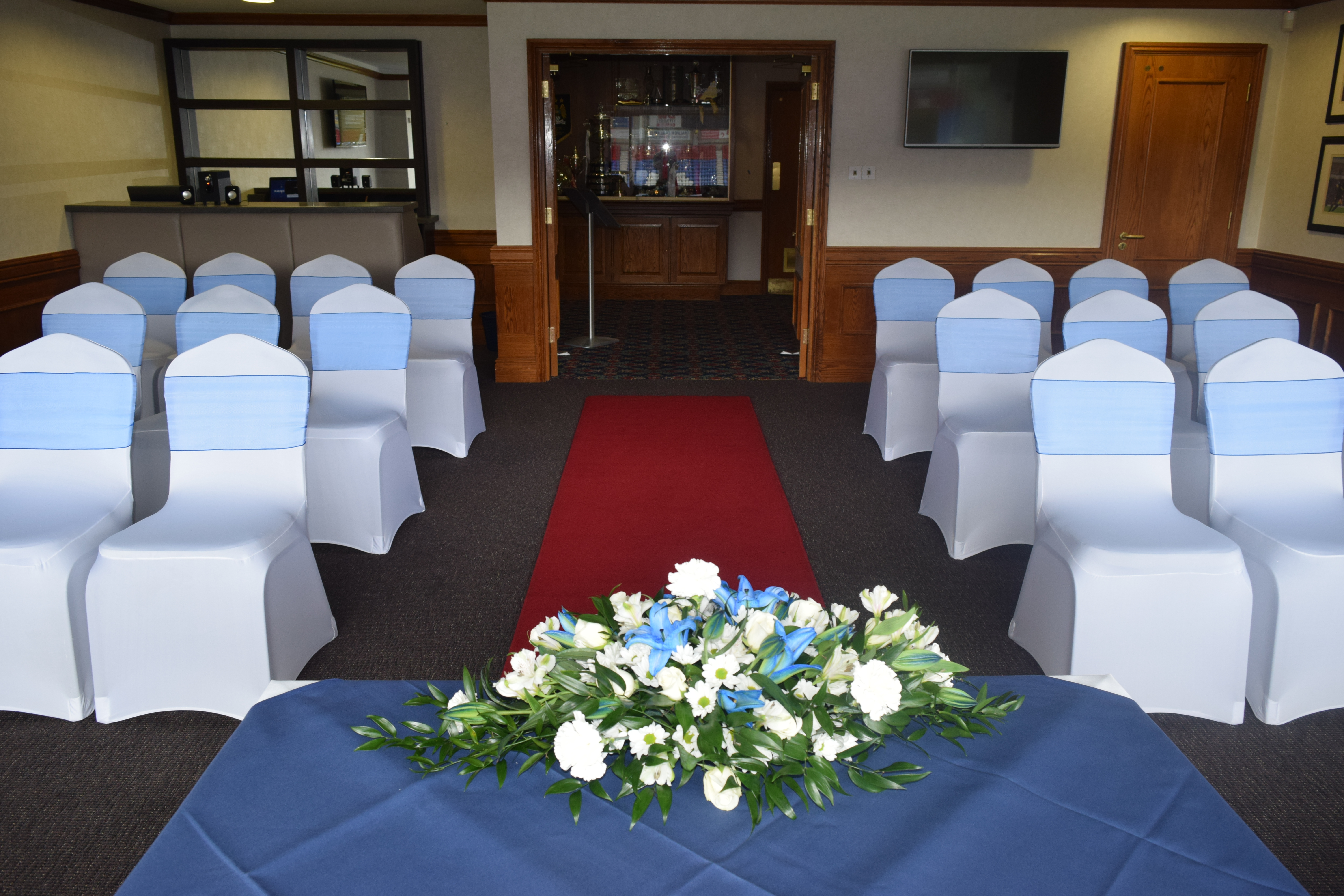 Dave Whelan President's Suite with blue chairs and red carpet, perfect for formal events.