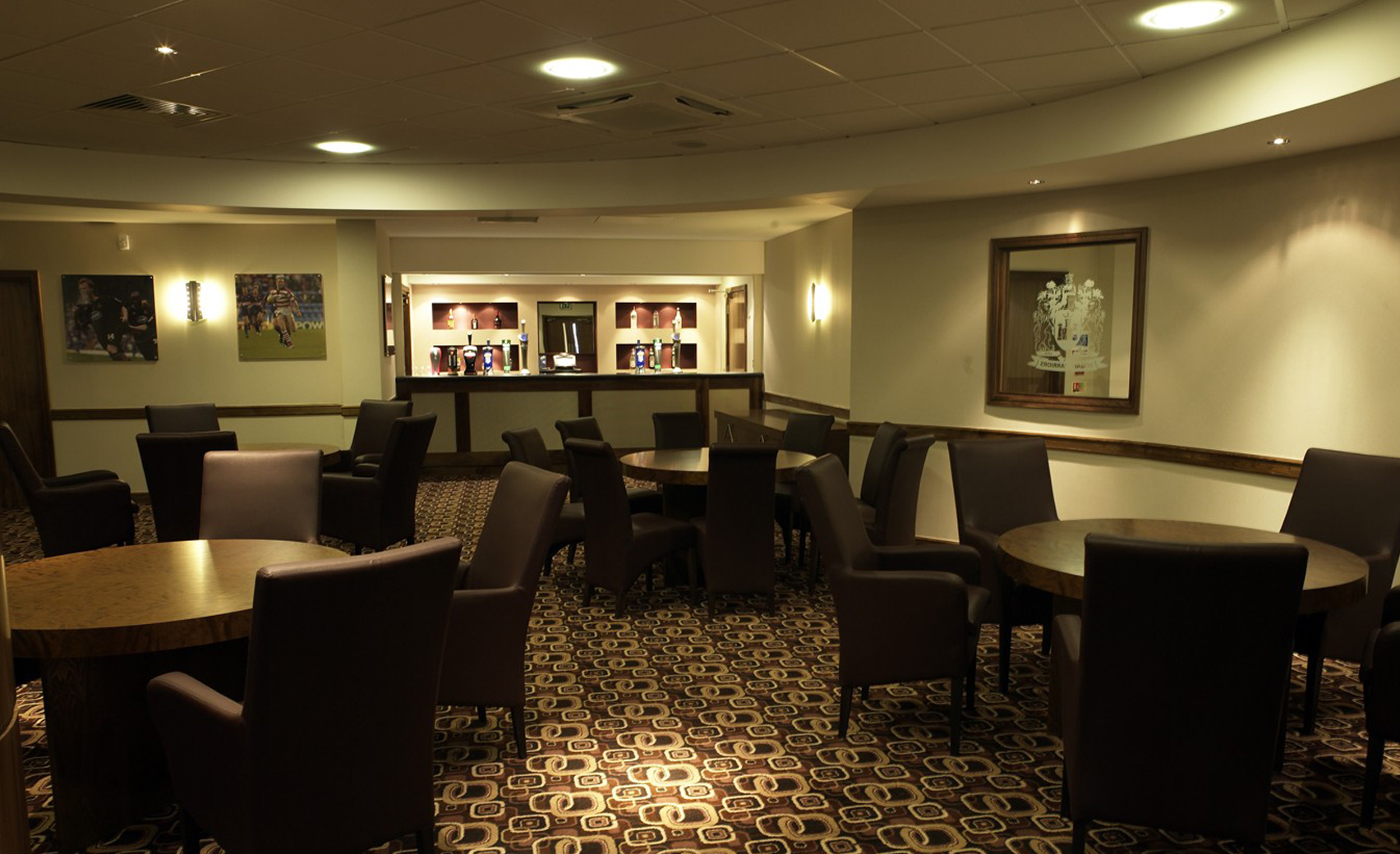 Players' Lounge at DW Stadium: inviting meeting space with round tables for networking events.