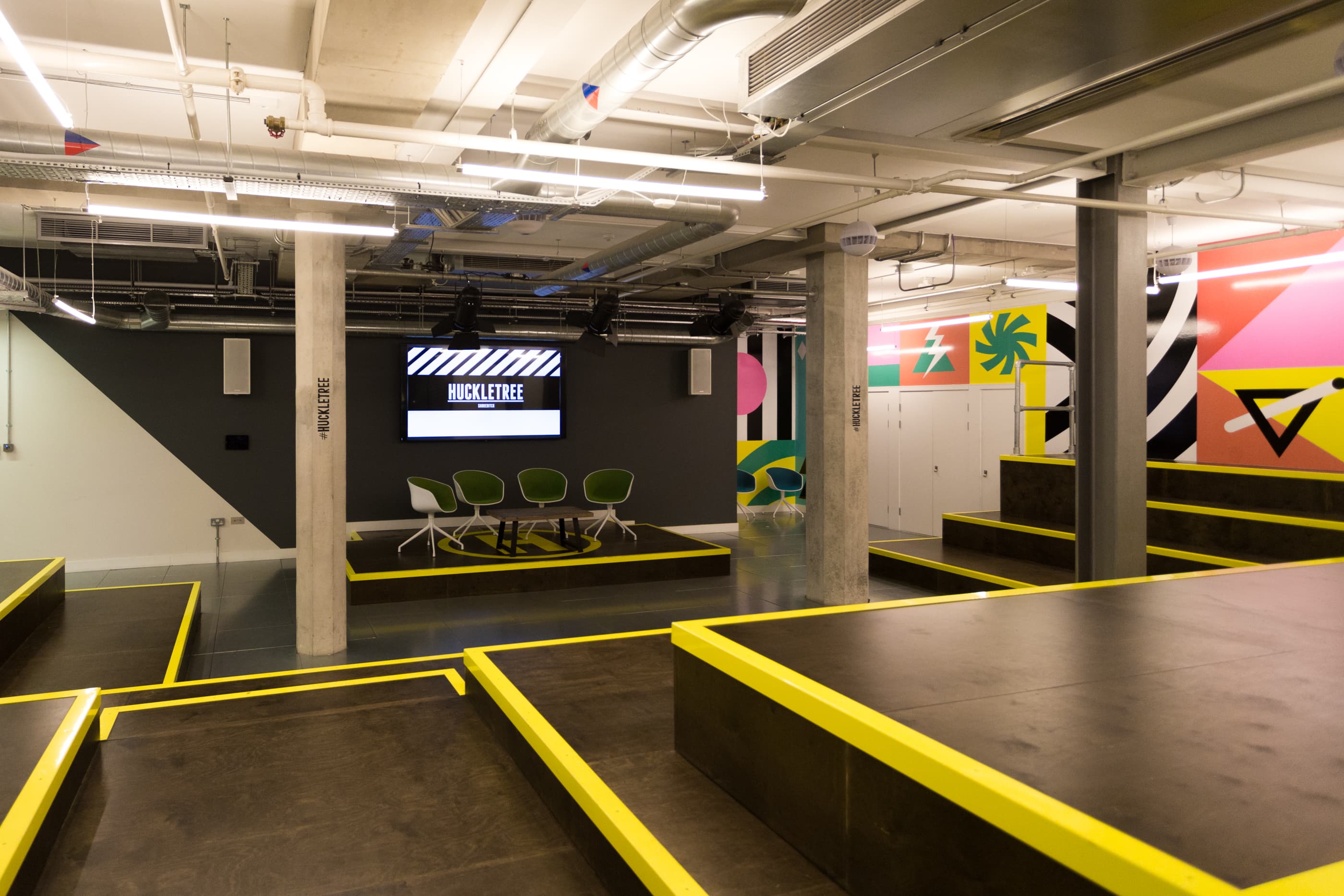 Modern event space with tiered seating, ideal for conferences in Huckletree Shoreditch.