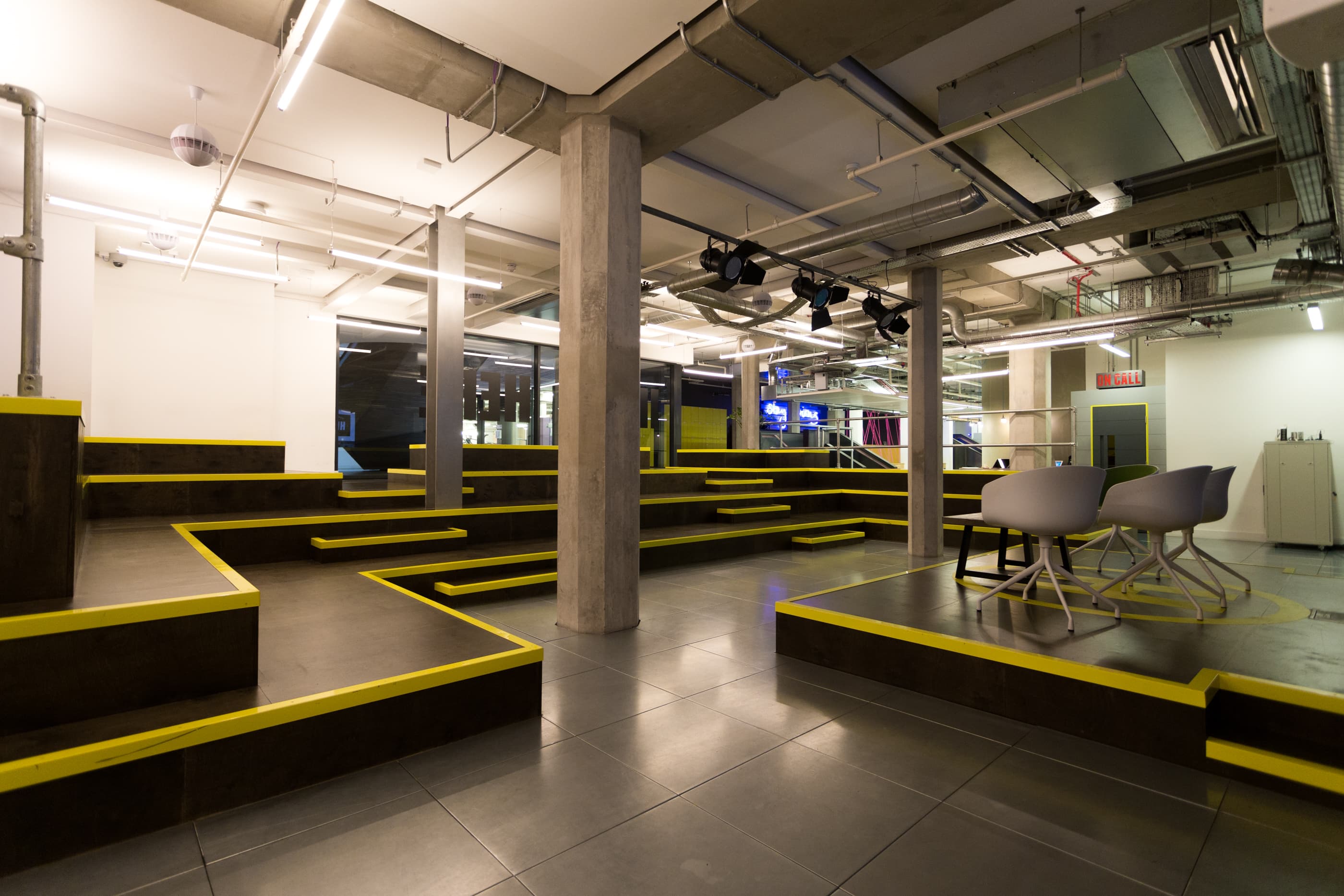 Auditorium event space in Huckletree Shoreditch with tiered seating for workshops and presentations.