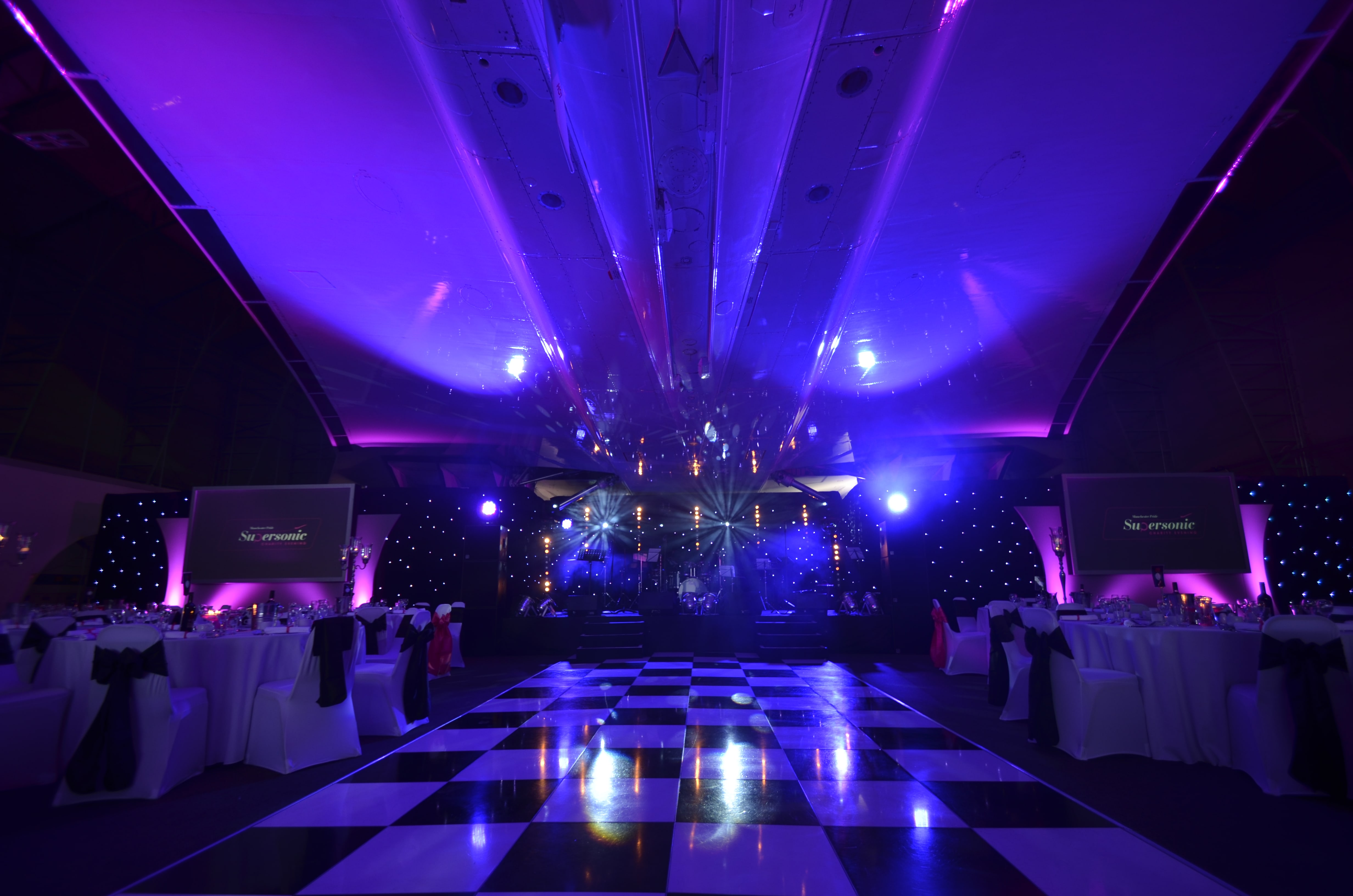 Elegant Christmas party setup at Concorde Conference Centre with dramatic lighting.