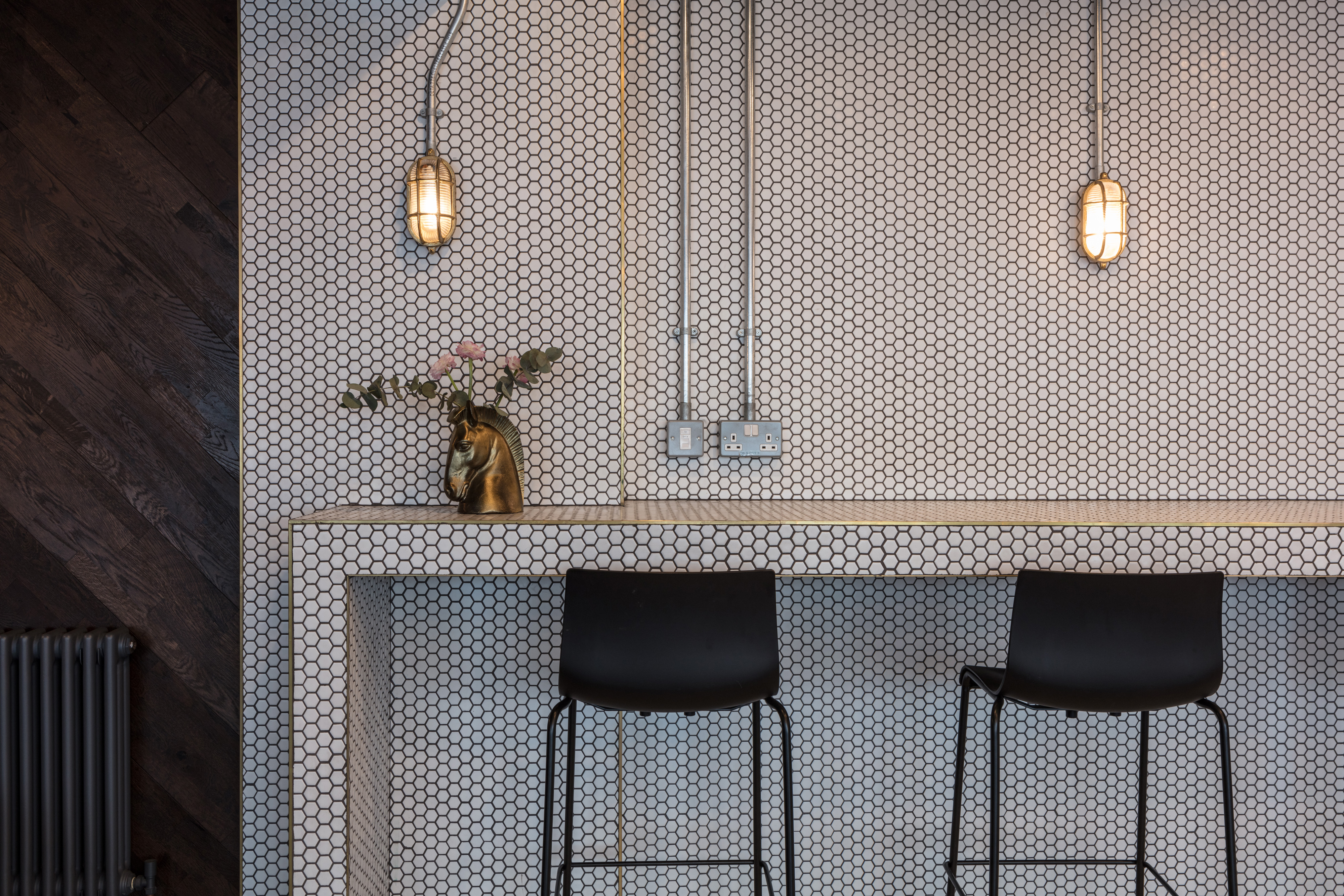 Modern bar area with hexagonal tiles, ideal for networking events in Brighton.