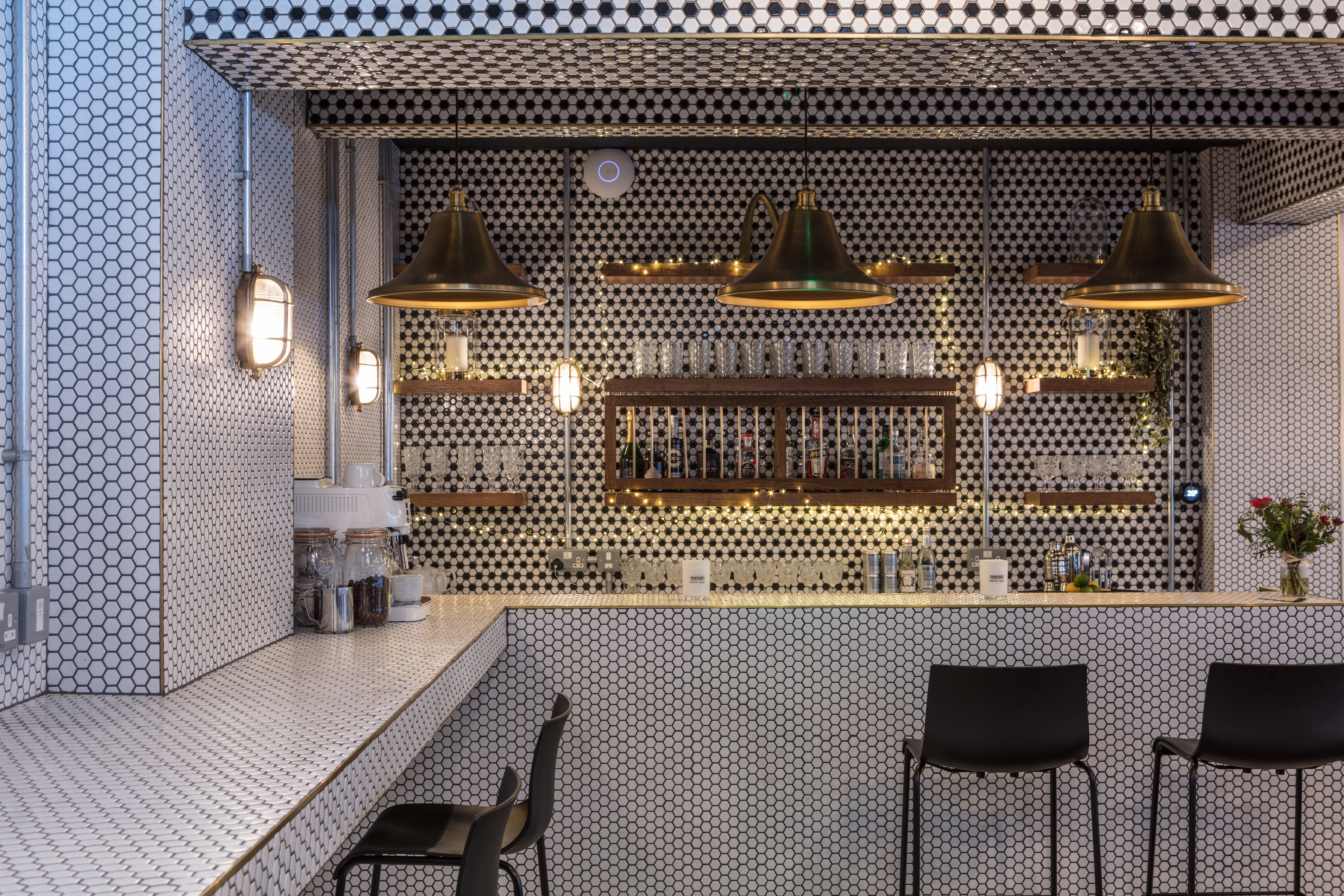 Stylish bar area with hexagonal tiles at The Vine Club Brighton for networking events.