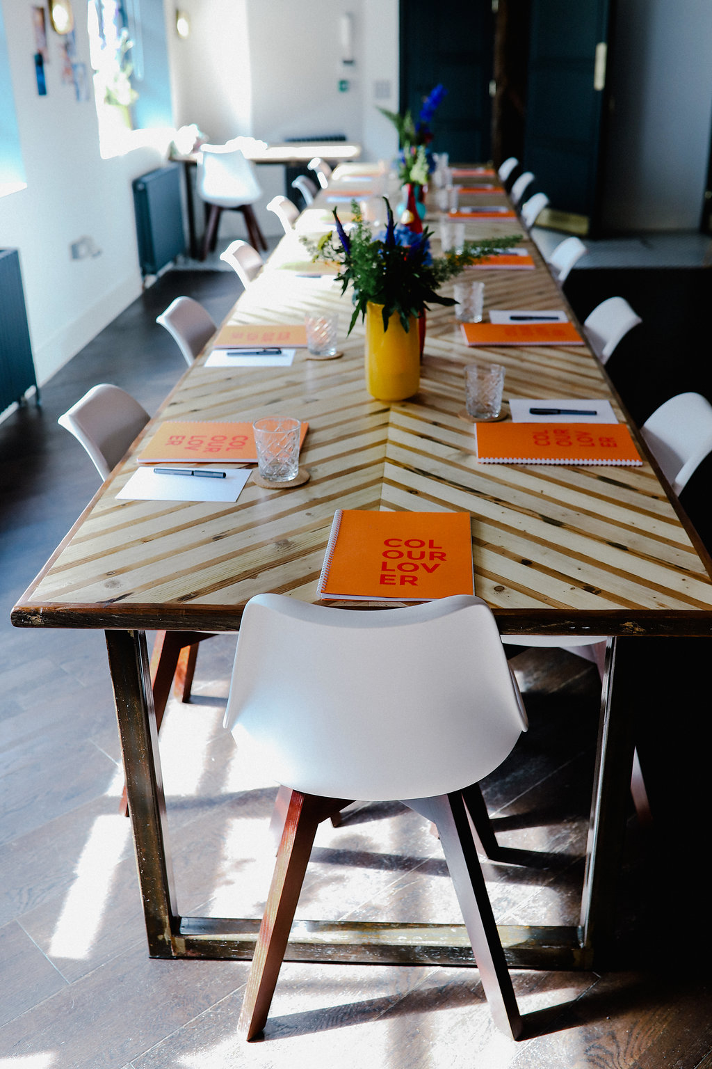 Stylish meeting space at The Vine Club Brighton with vibrant notebooks for collaboration.