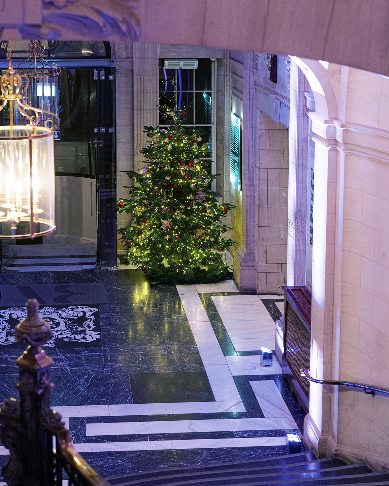 Festive Christmas party lobby decor at Westminster event venue, Carlton House Terrace.
