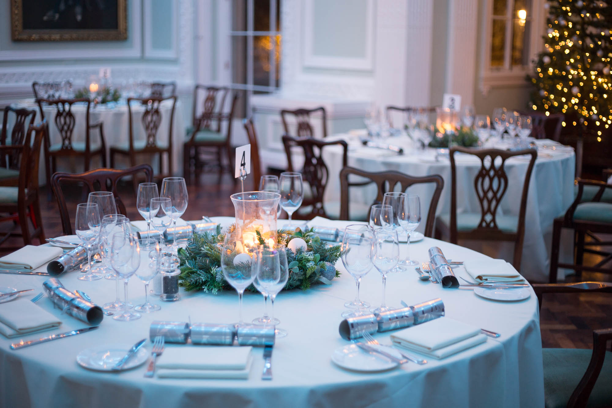 Elegant dining room for Christmas party at Carlton House Terrace, featuring festive decor.