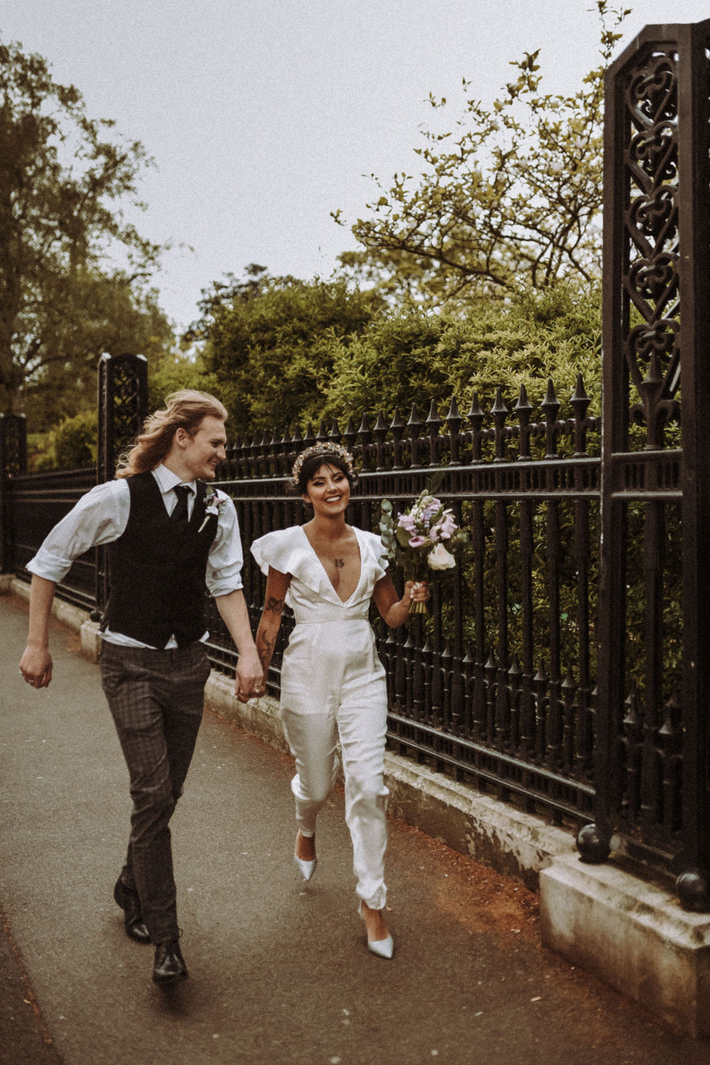 Joyful couple on wedding day at 41 Portland Place, lush greenery backdrop, Christmas event.