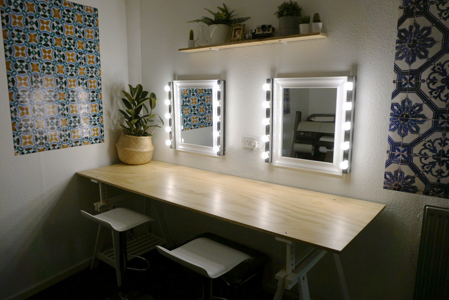Vanity area with illuminated mirrors in Tanzaro Creative Studio for event preparations.