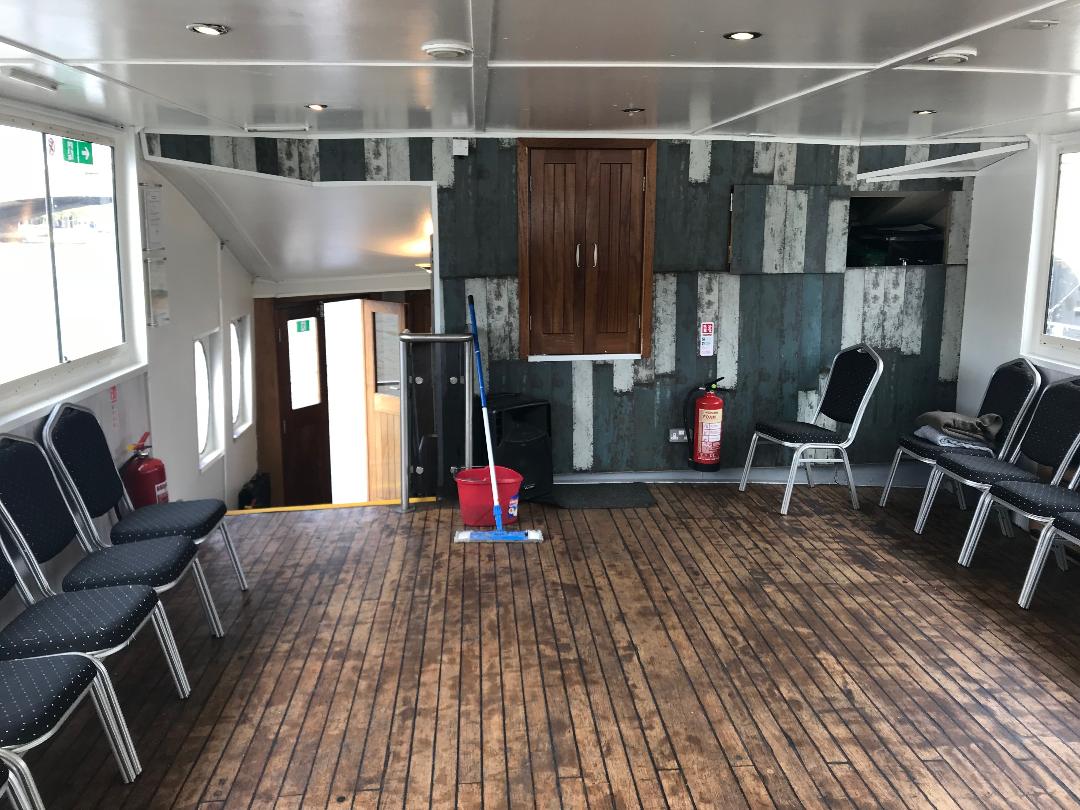 Versatile meeting space in MV King Edward with wooden flooring for workshops and gatherings.